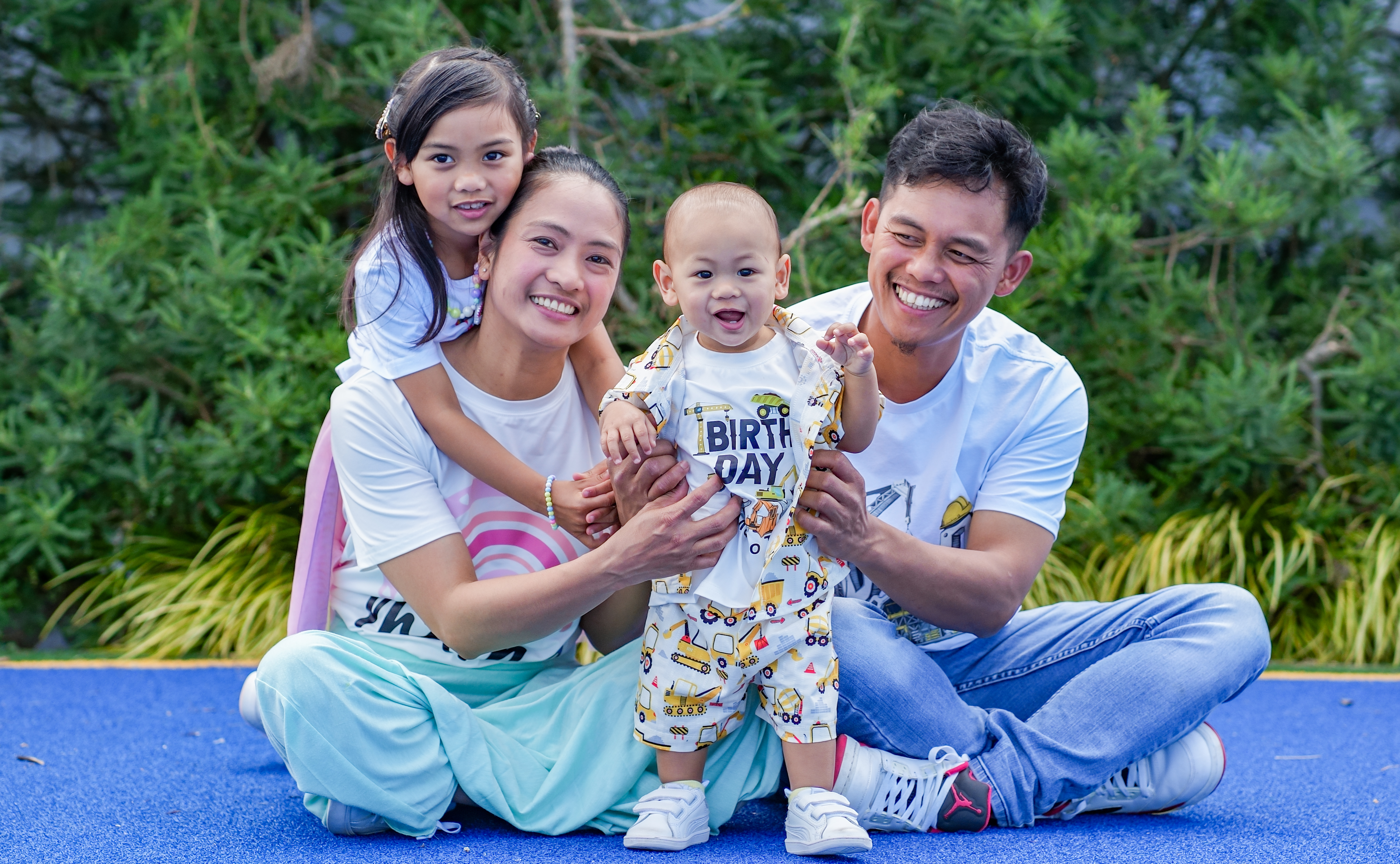 A family photographed outdoors in Auckland