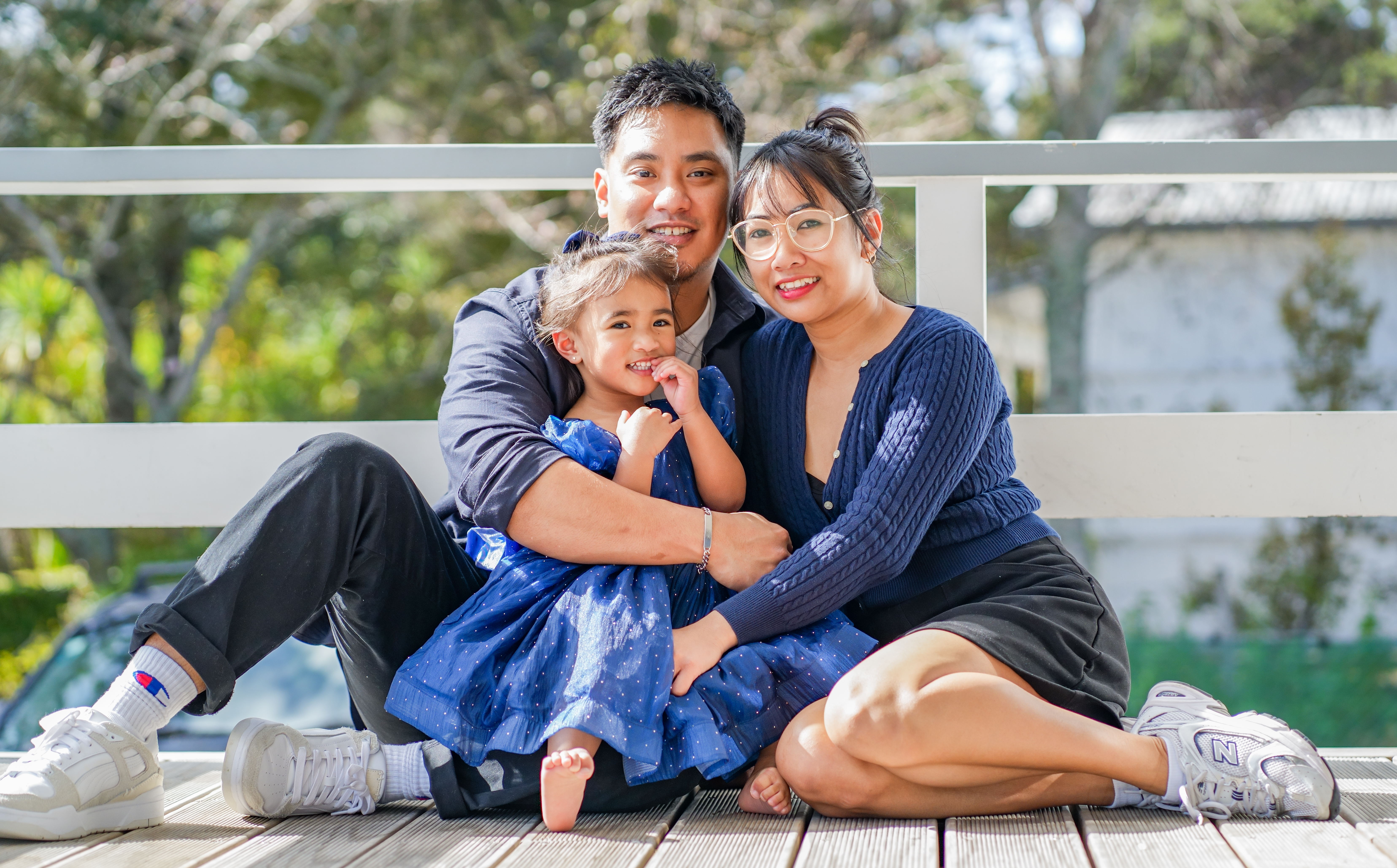 A family photographed outdoors in Auckland