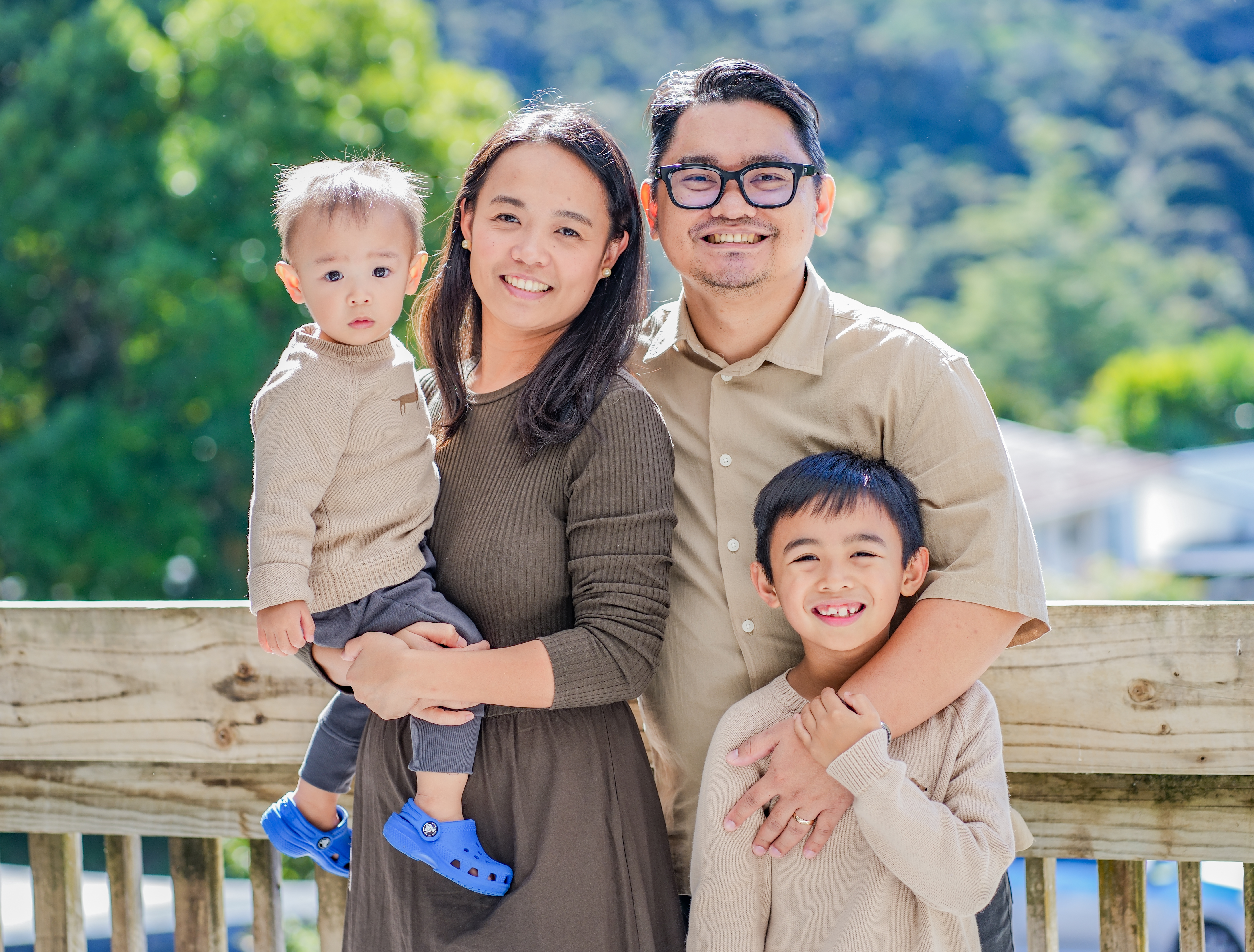 A family photographed outdoors in Auckland