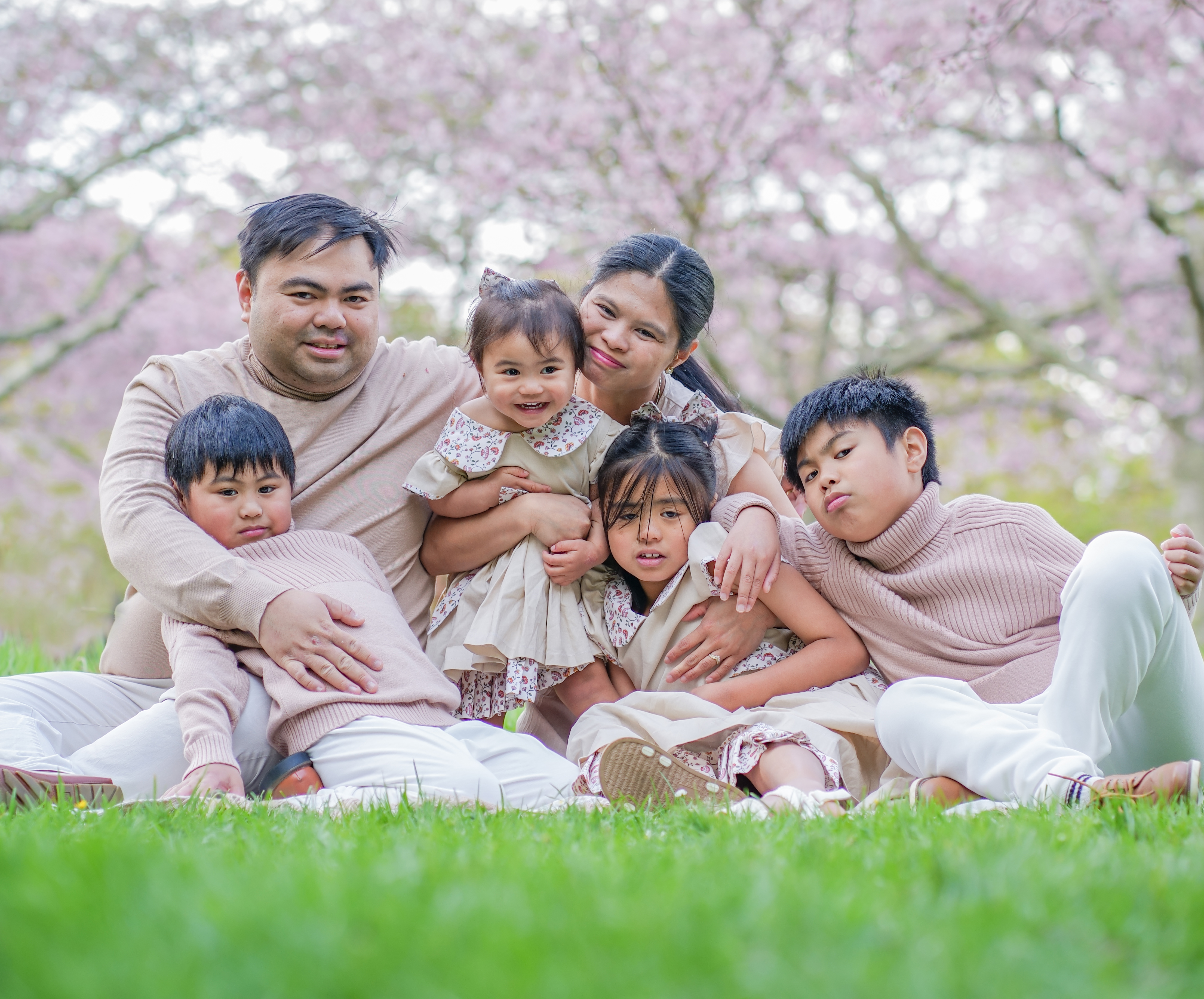 A family photographed outdoors in Auckland
