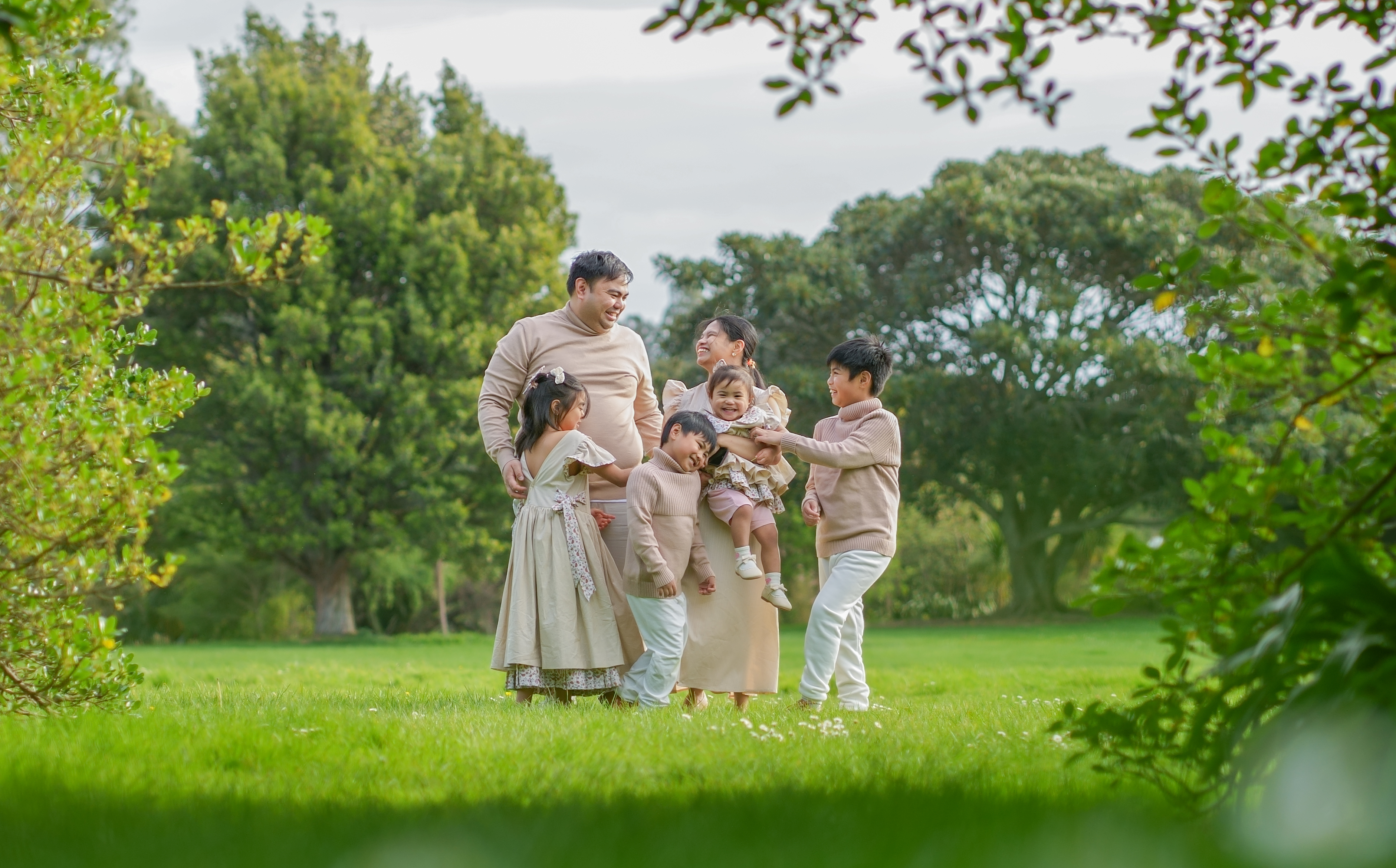 A family photographed outdoors in Auckland