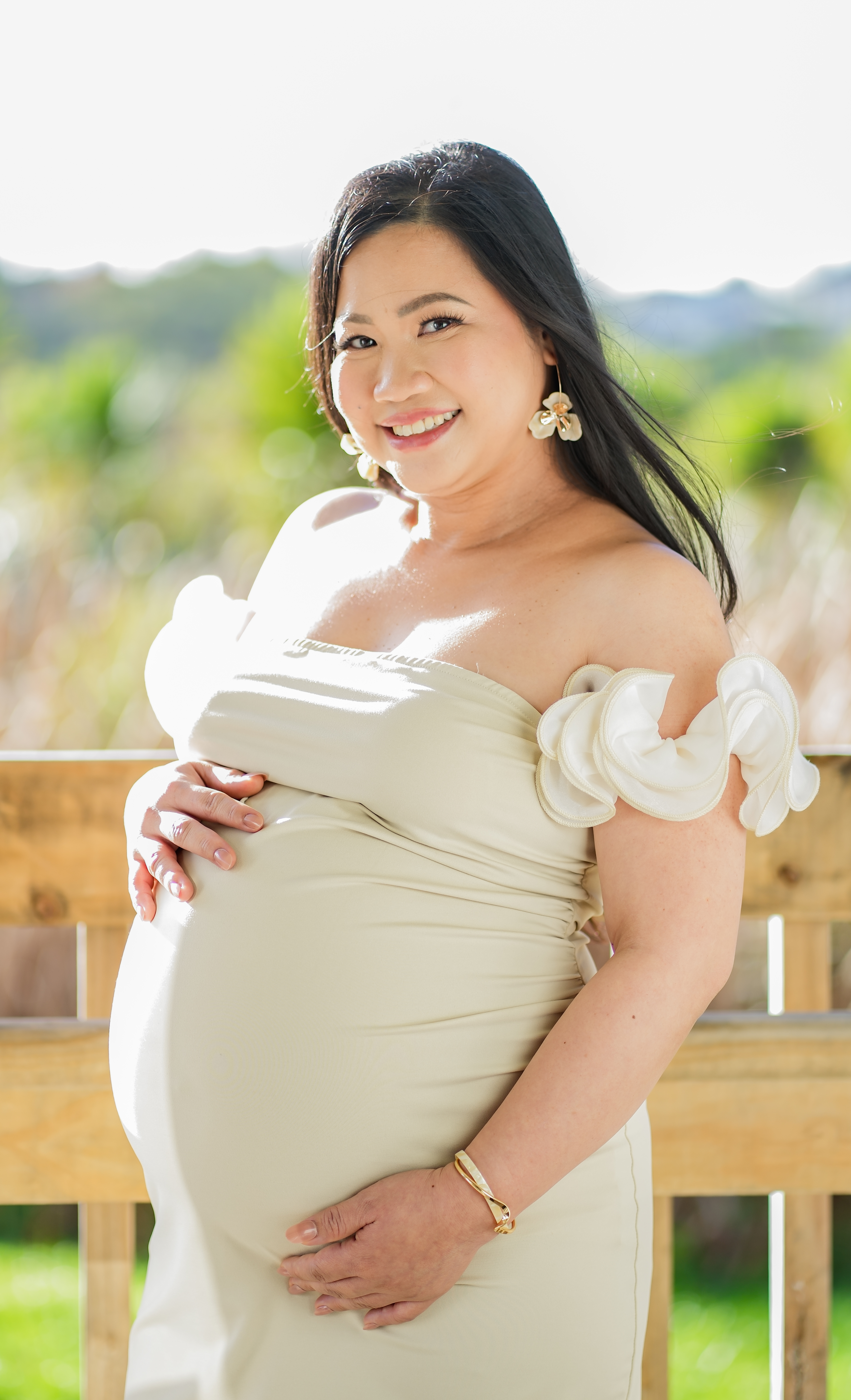 An expectant mother photographed in a cream gown