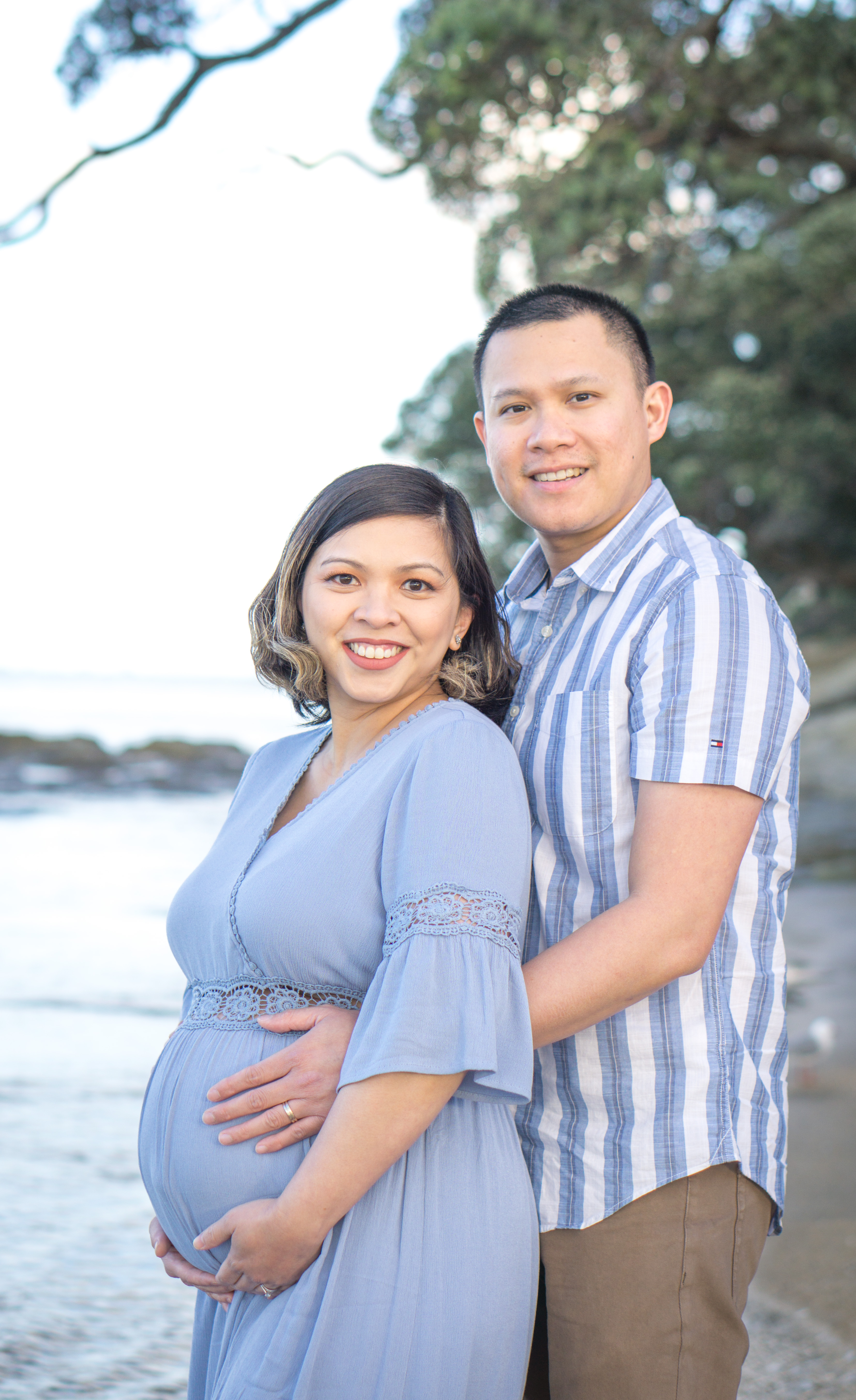 An expectant couple photographed on the coast