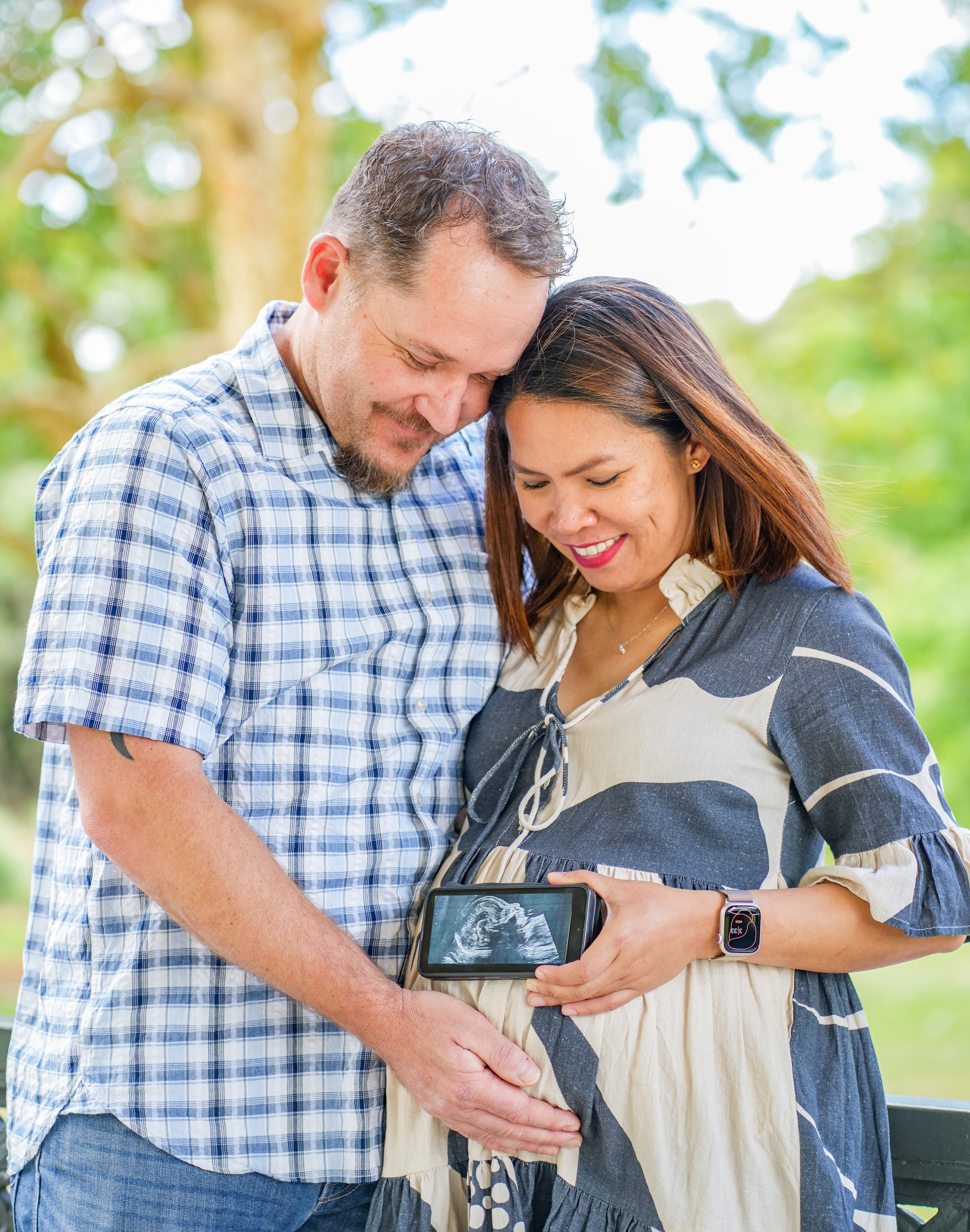 An expectant couple photographed close together