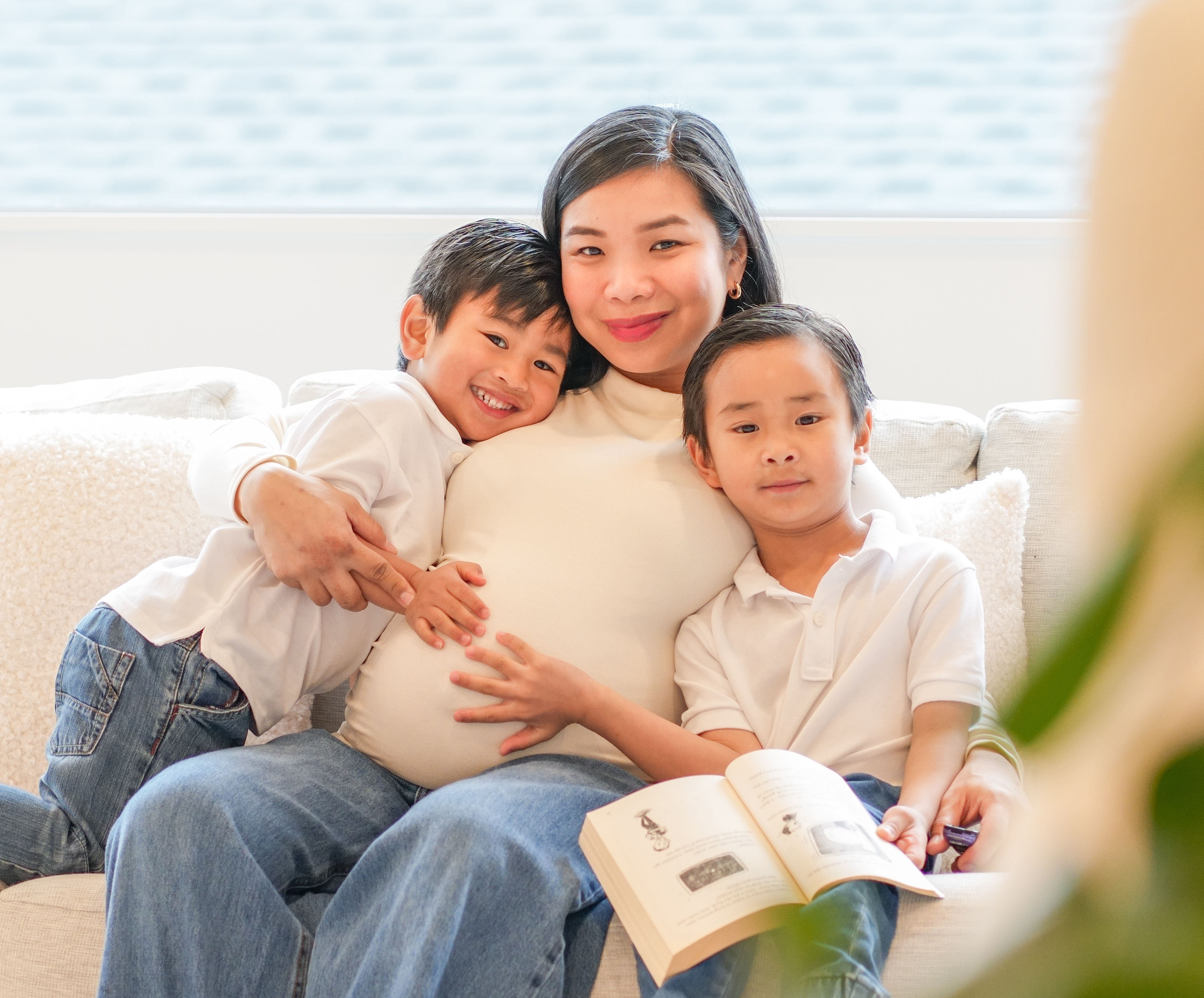 An expectant mother with her two sons