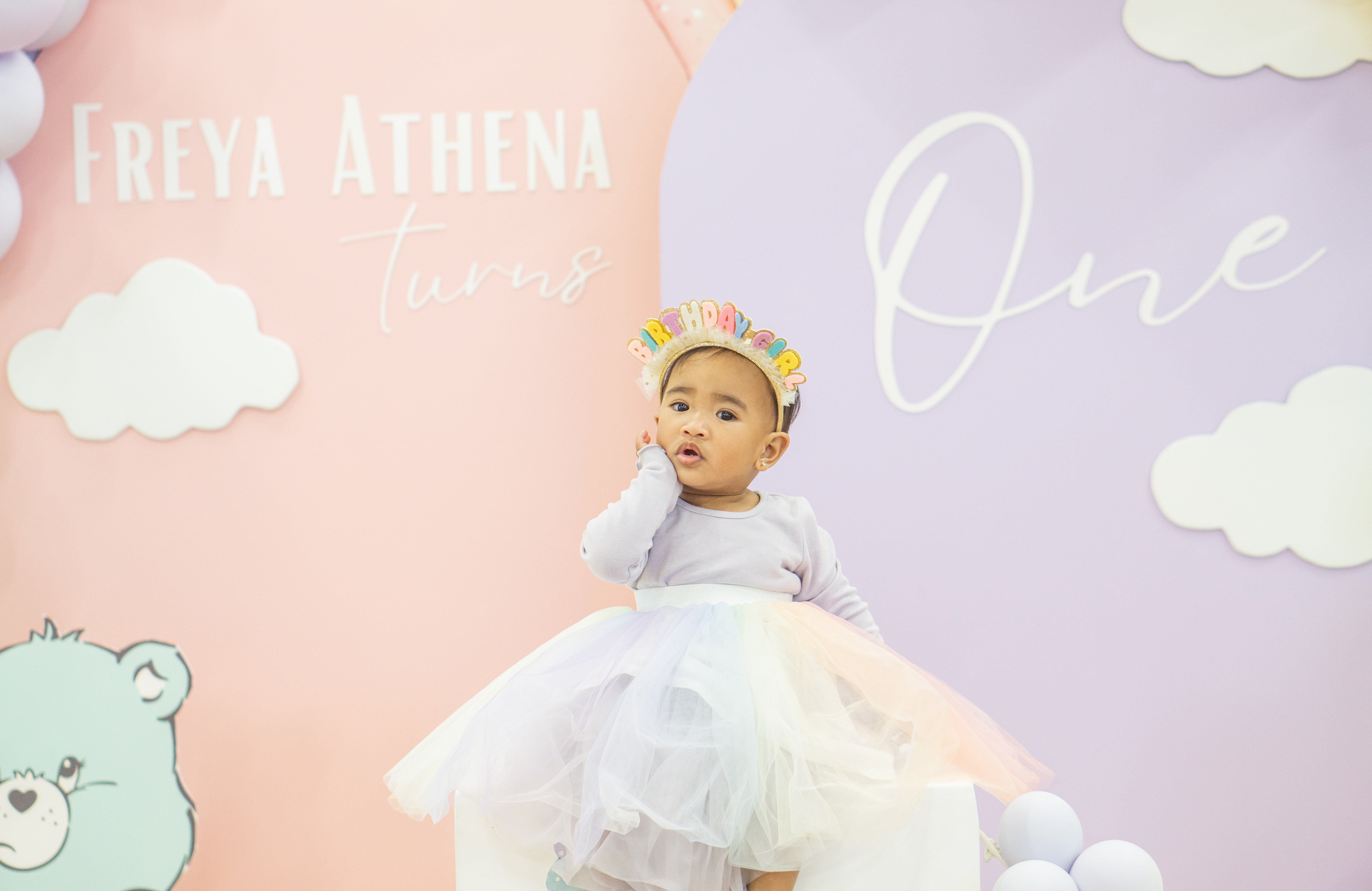 A little girl in a white tutu at her first birthday