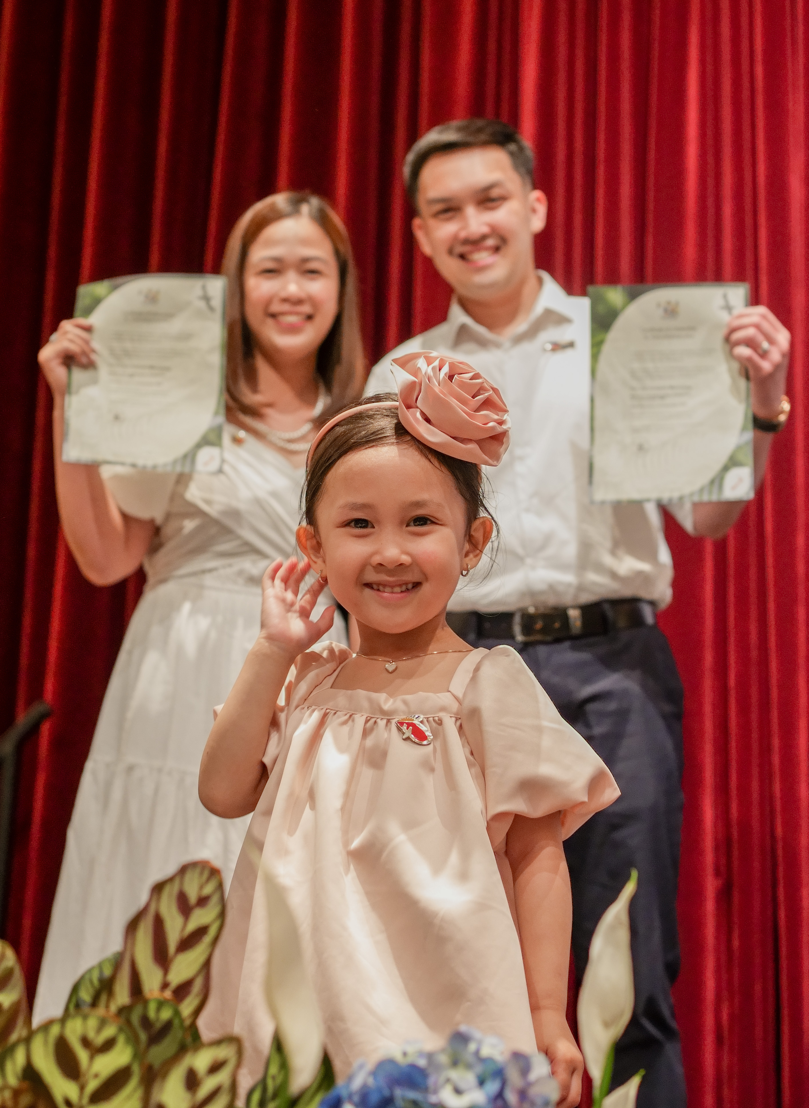 Parents celebrating a graduation with their daughter