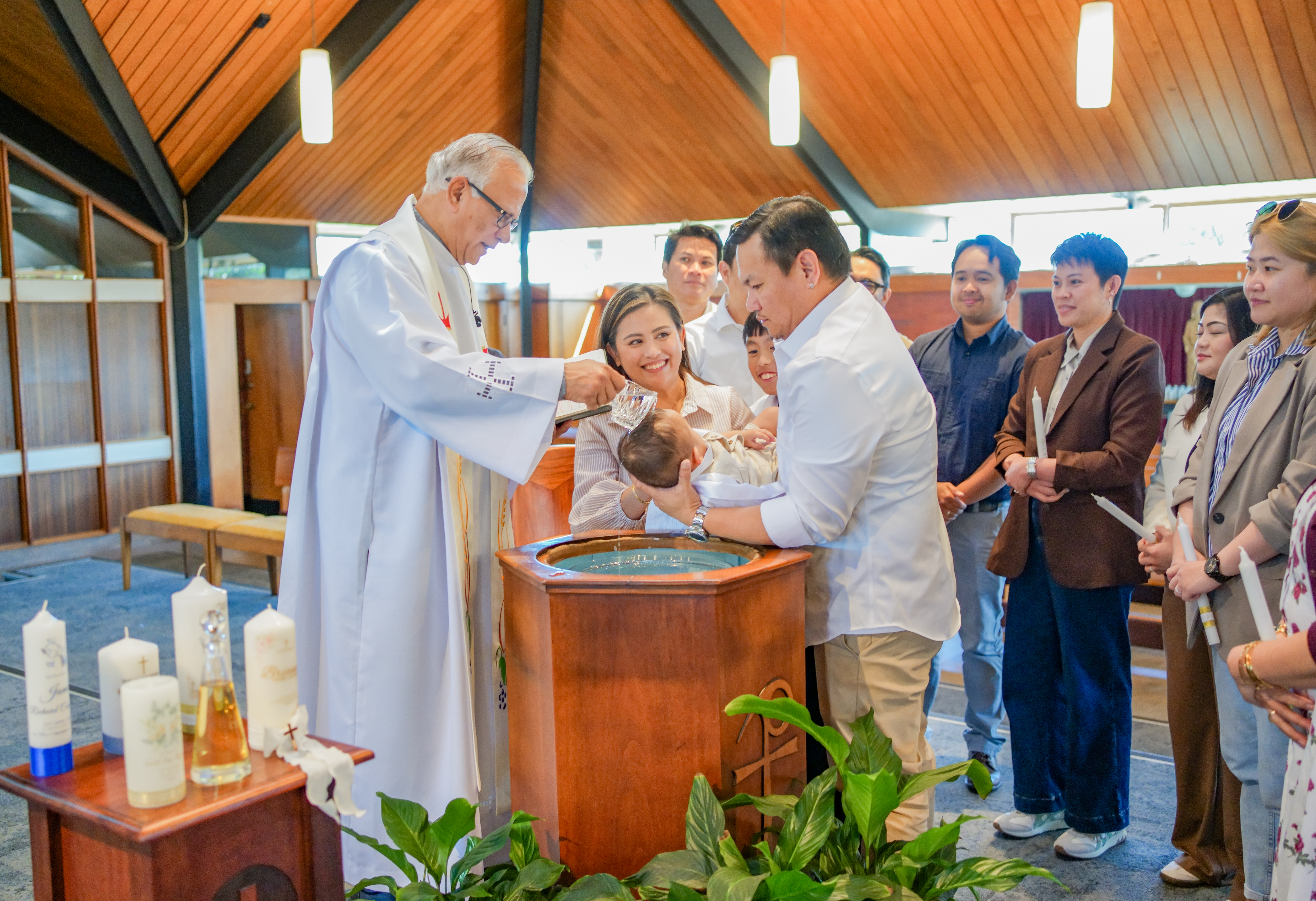 A baby being baptised at the font