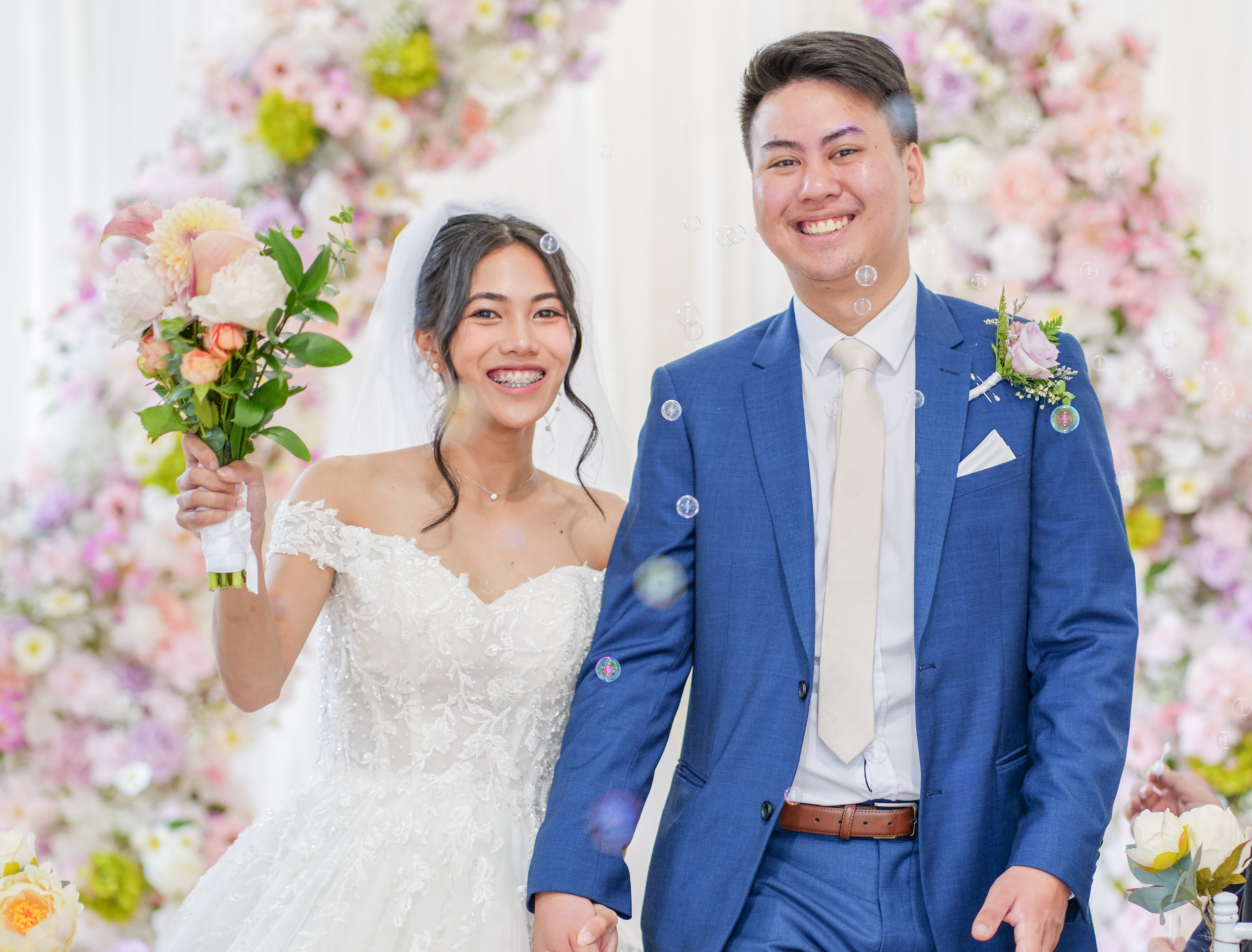 A newly married couple walking back down the aisle