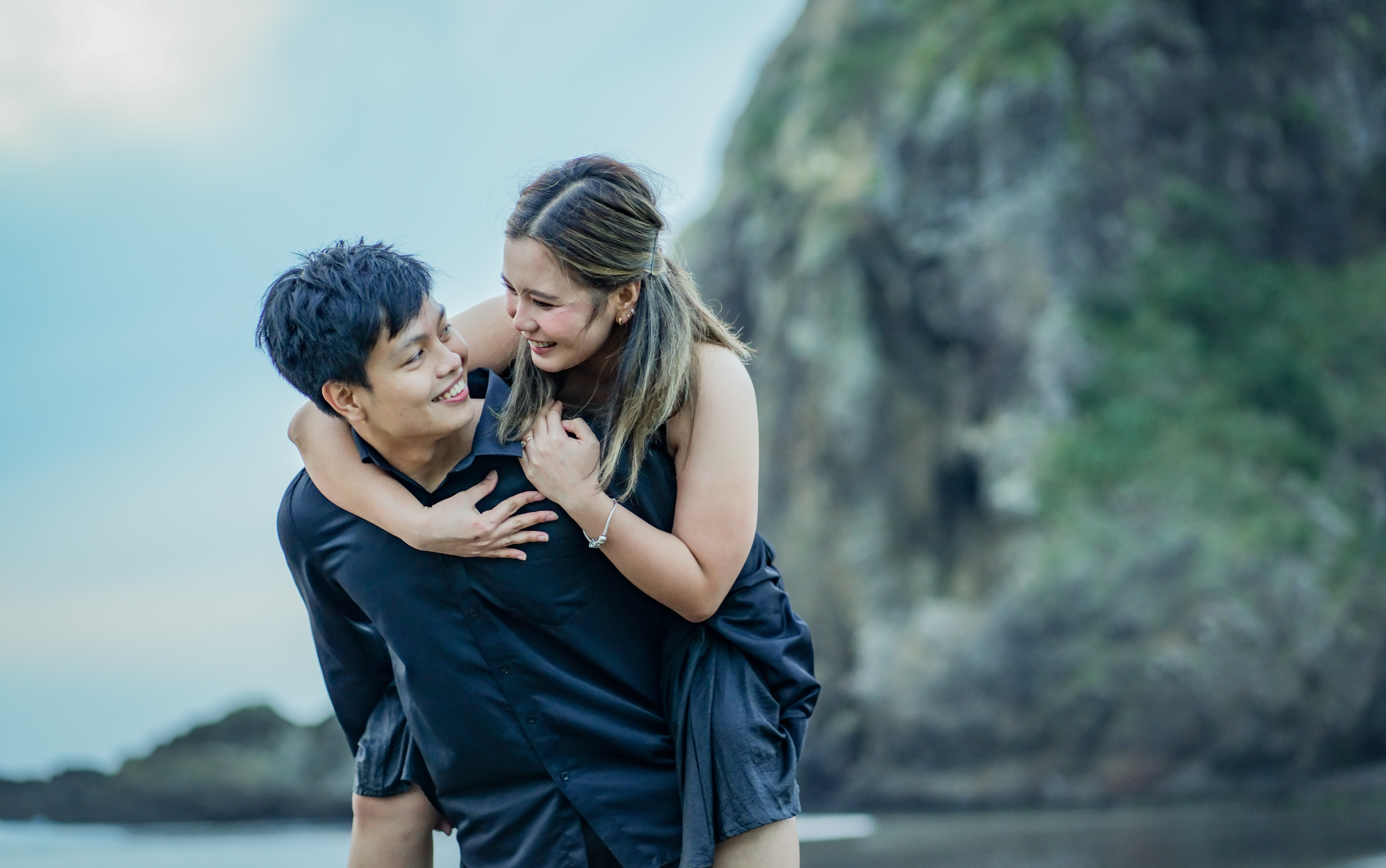 A couple photographed together on the coast