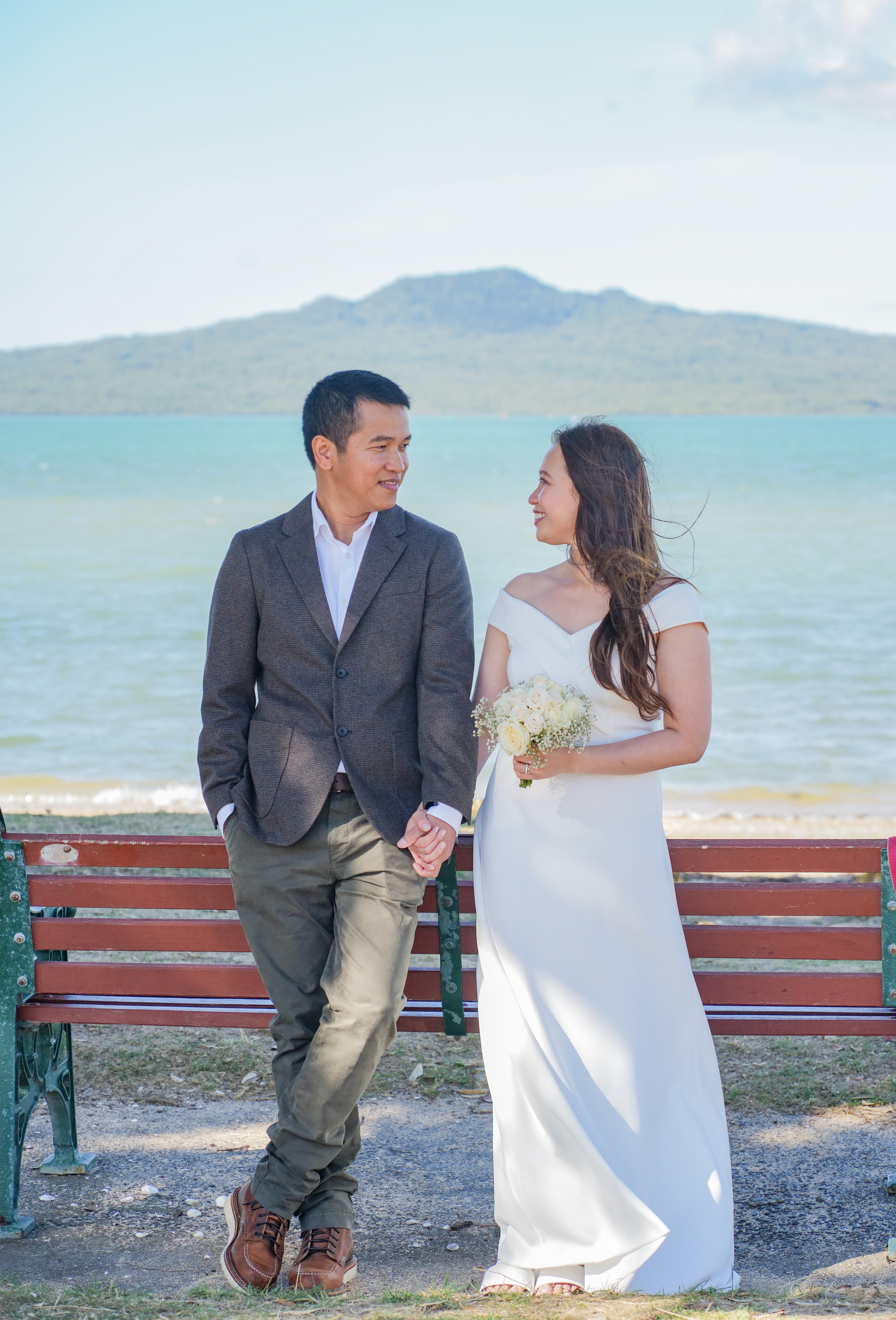 A bride and groom photographed by the sea