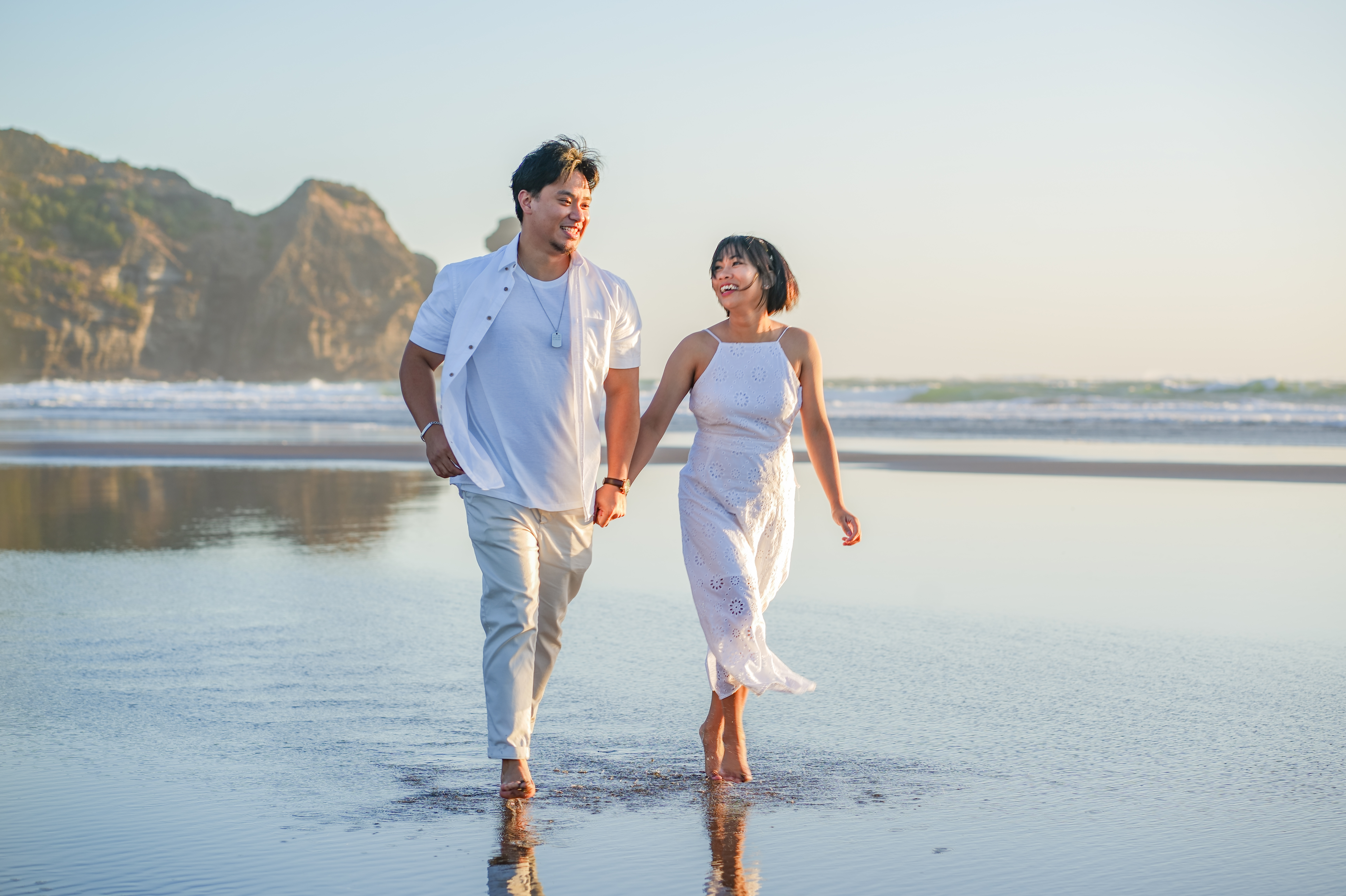 A couple running along the shoreline