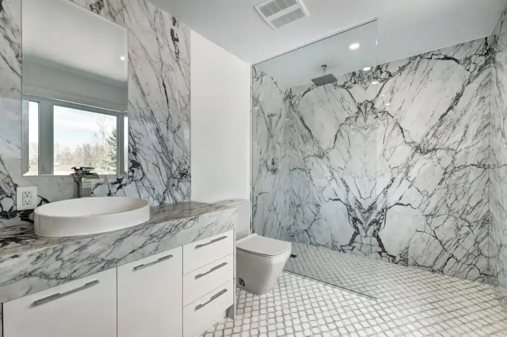 Luxury ensuite bathroom renovation with elegant vanity, refined tile work, and warm high-end finishes