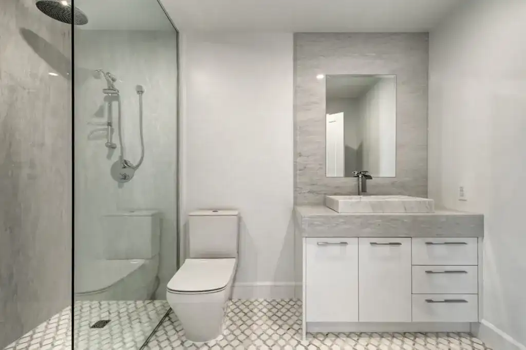 Custom laundry cabinetry with clean white storage in a modern condo