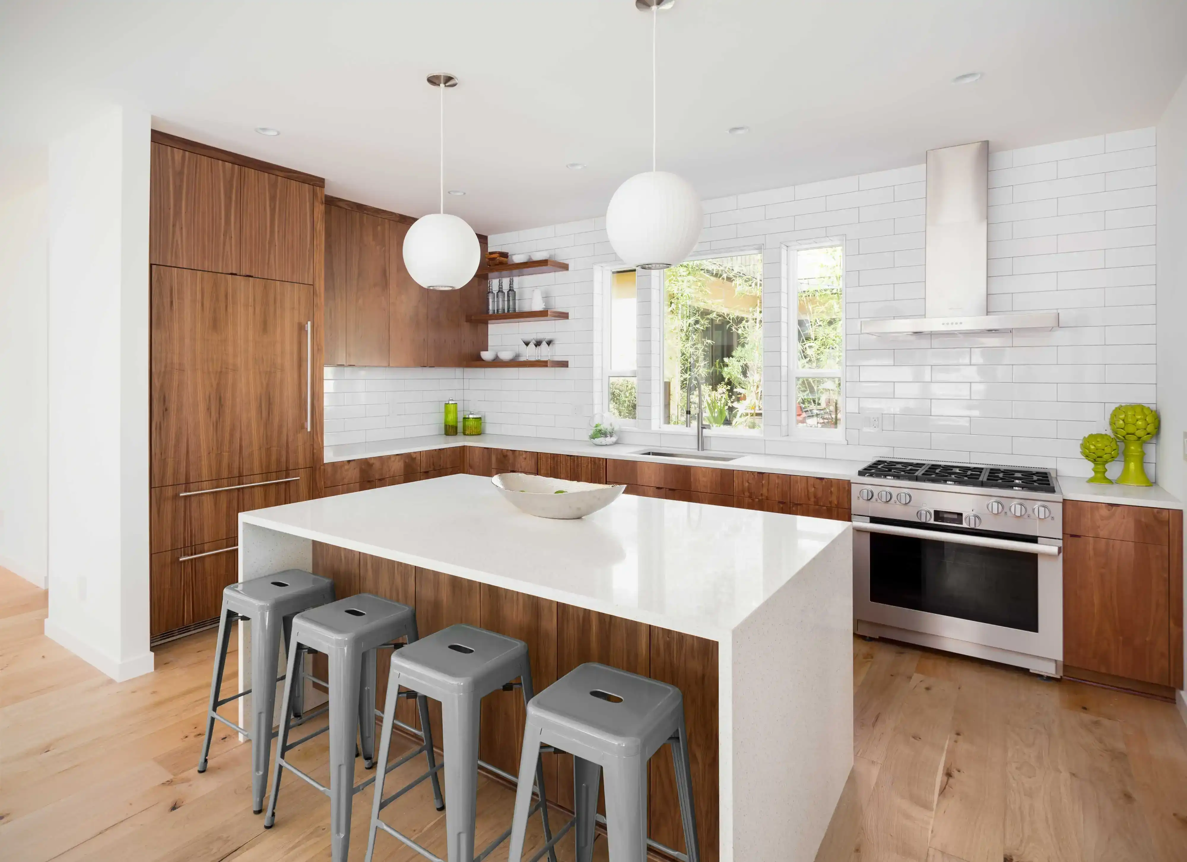 Walnut kitchen with quartz waterfall island and pendant lighting
