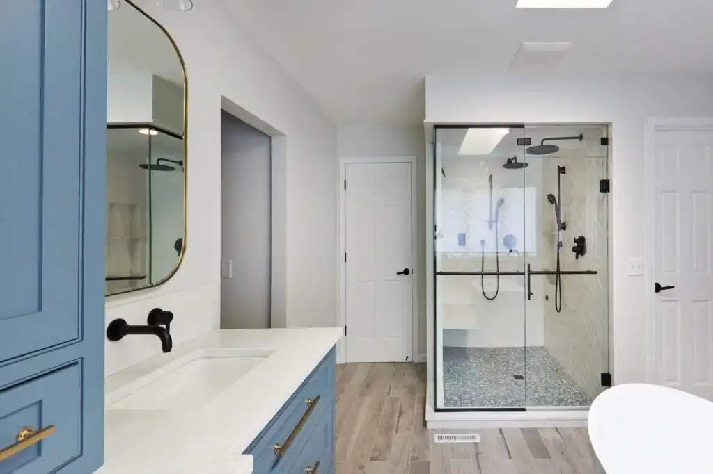 Spa ensuite with freestanding tub, skylight, and warm natural tones