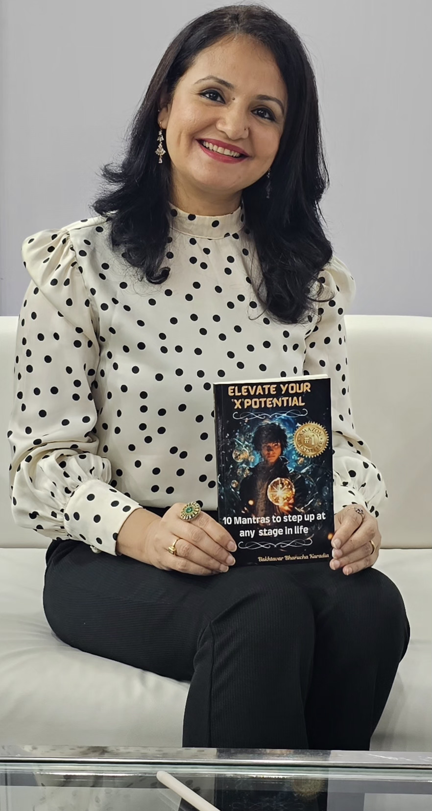 Bakhtavar Karadia holding her book Elevate Your 'X'Potential