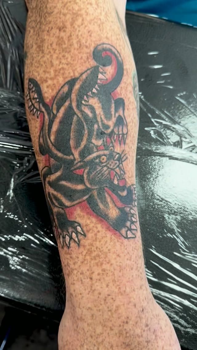 Traditional-style color Dungeons & Dragons creature tattoo on the forearm