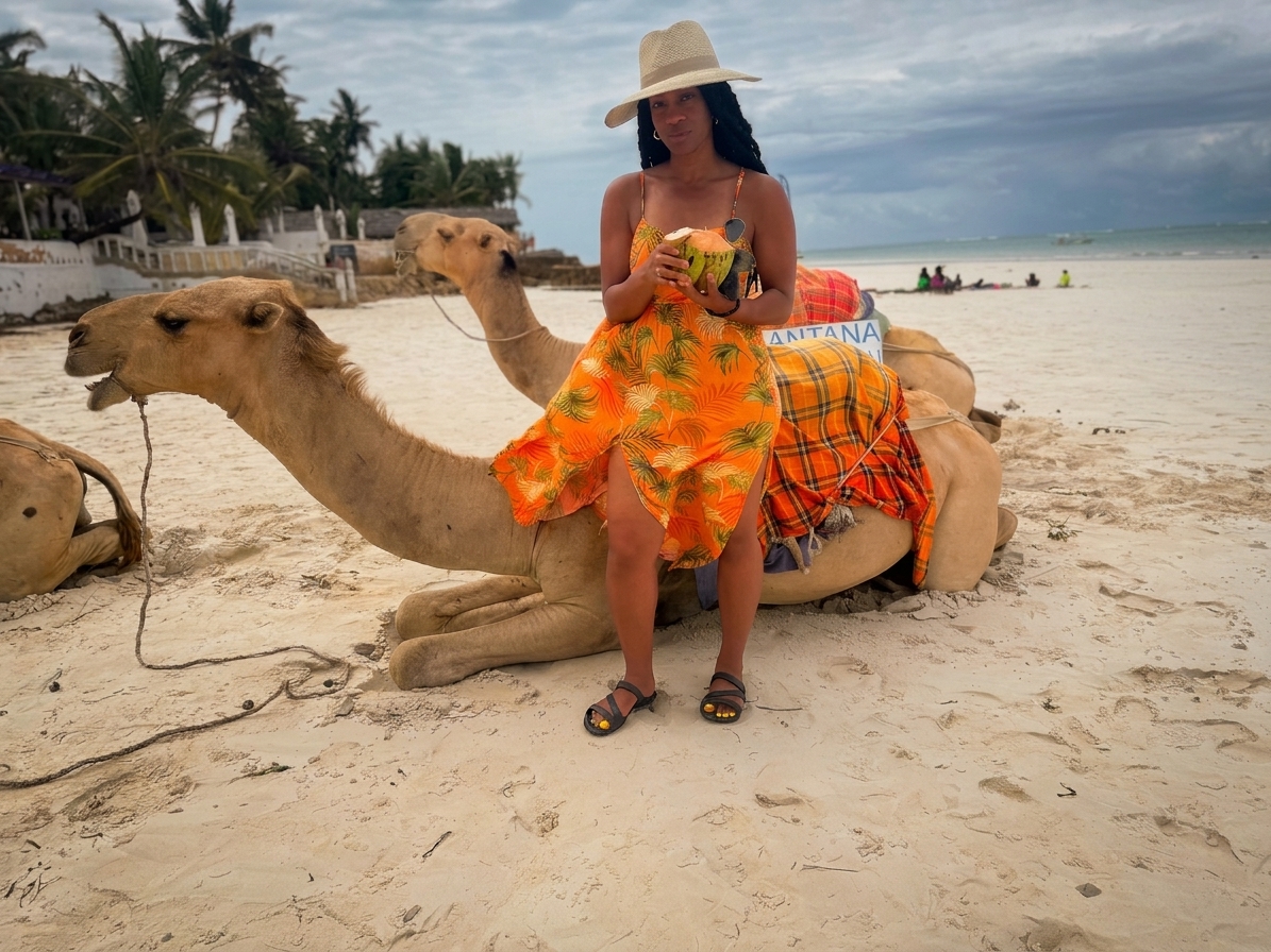 Woman enjoying a coconut while sitting on a camel at the beach