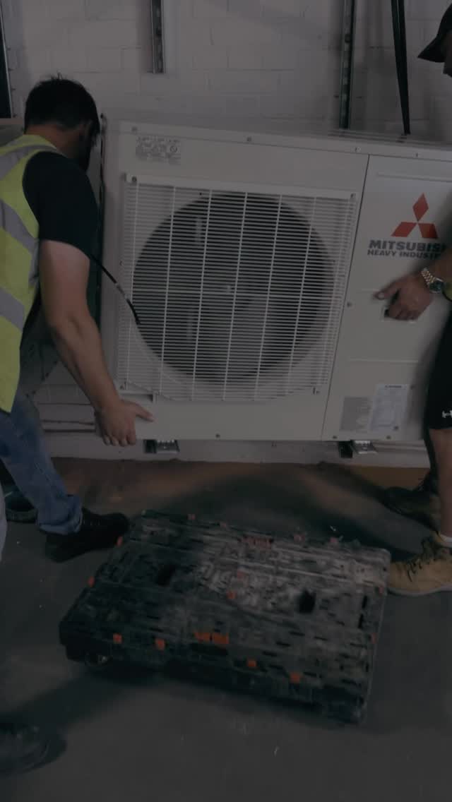 F-Gas registered engineer servicing an air conditioning unit