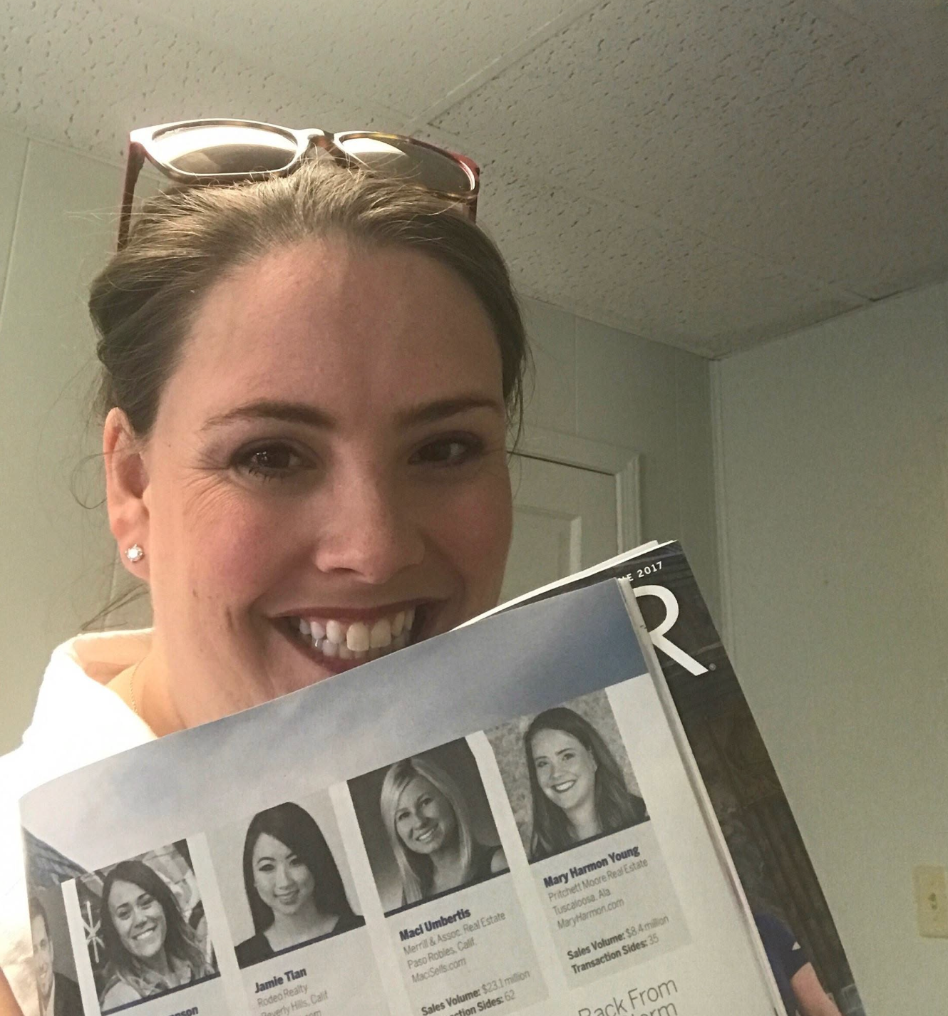 Mary Harmon Young holding REALTOR&reg; Magazine open to her 30 Under 30 Class of 2017 feature