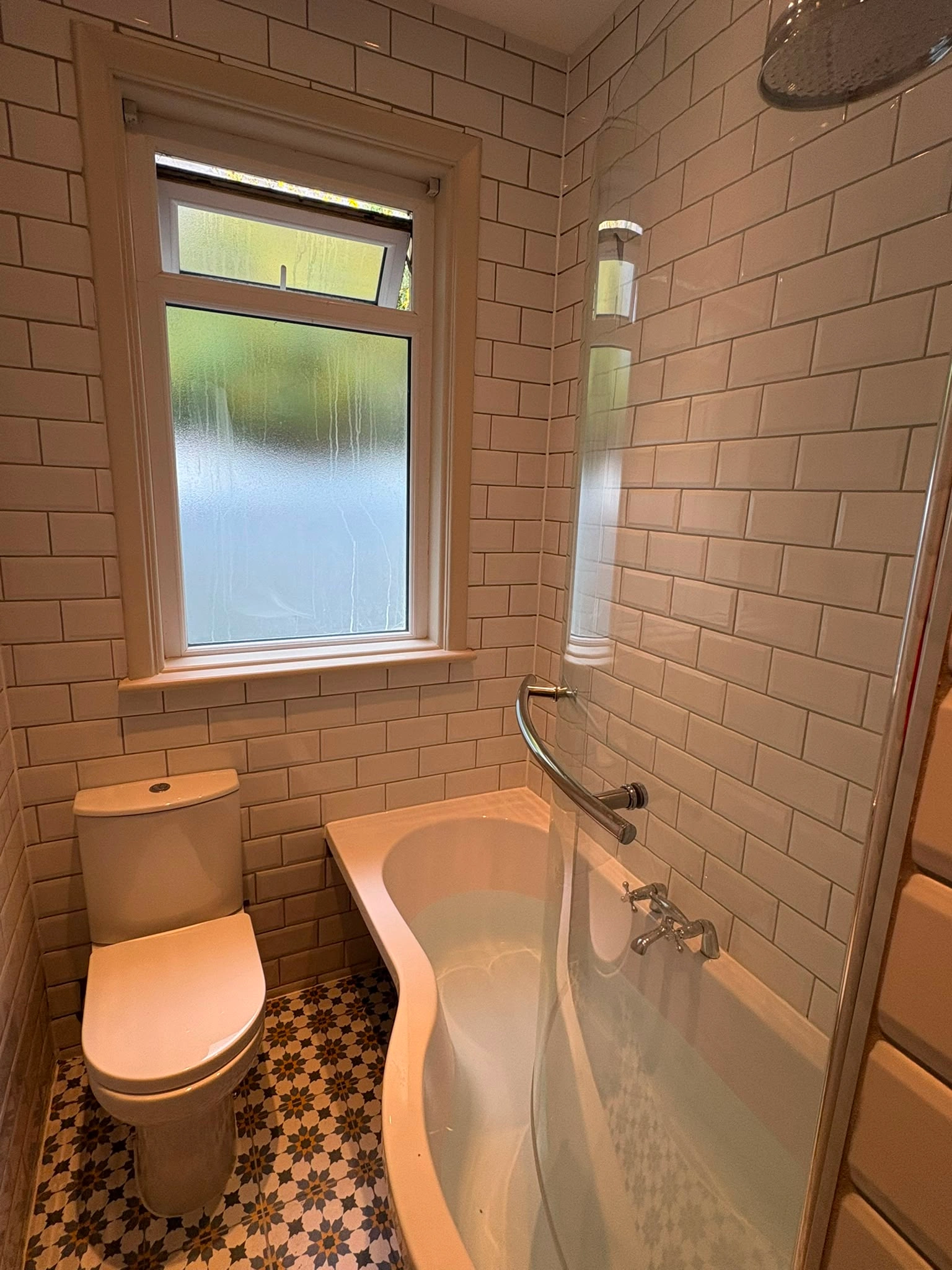 Gloss white subway tiling in bathroom