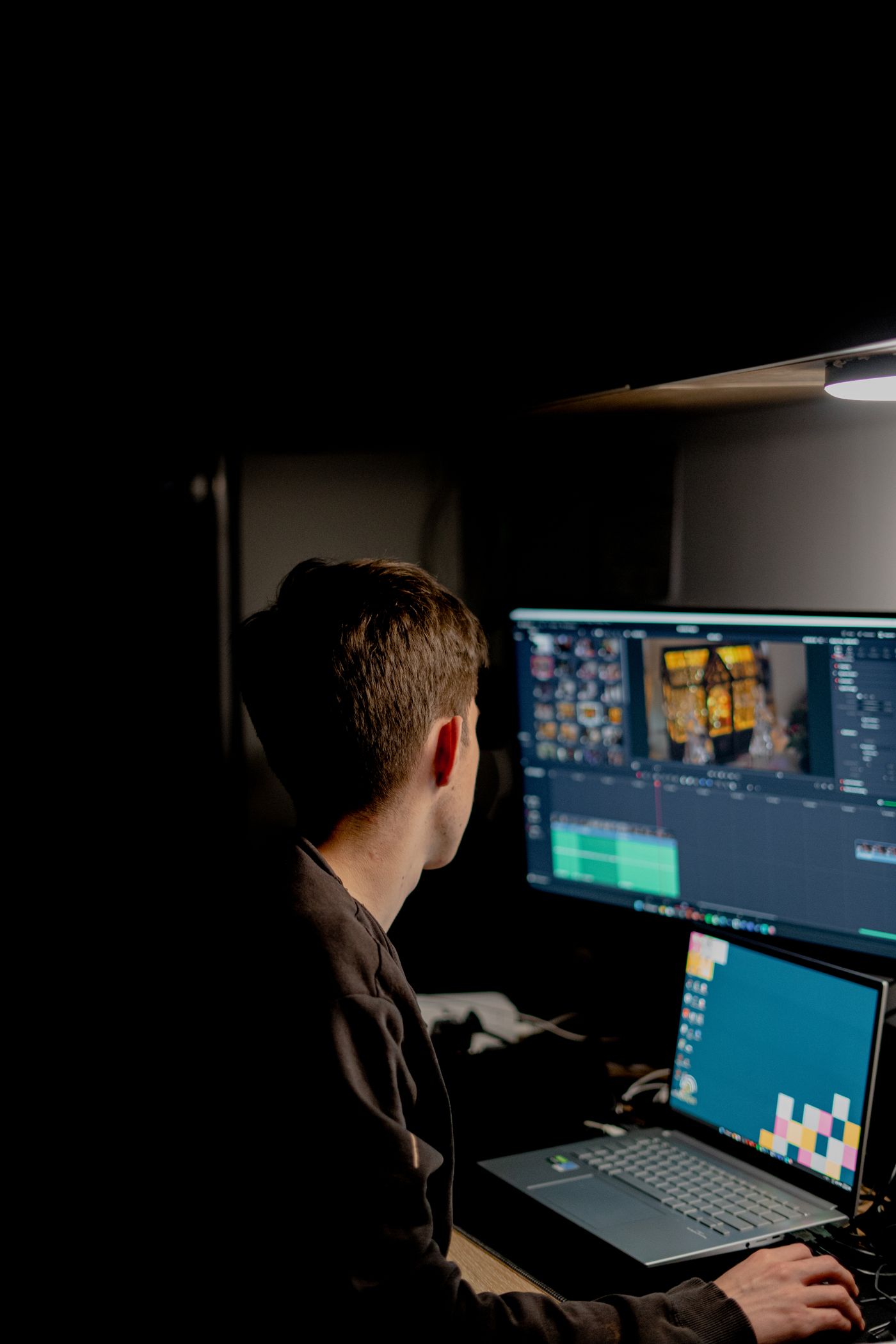 Editor cutting a video on a multi-monitor timeline — illustrative, not real client footage.