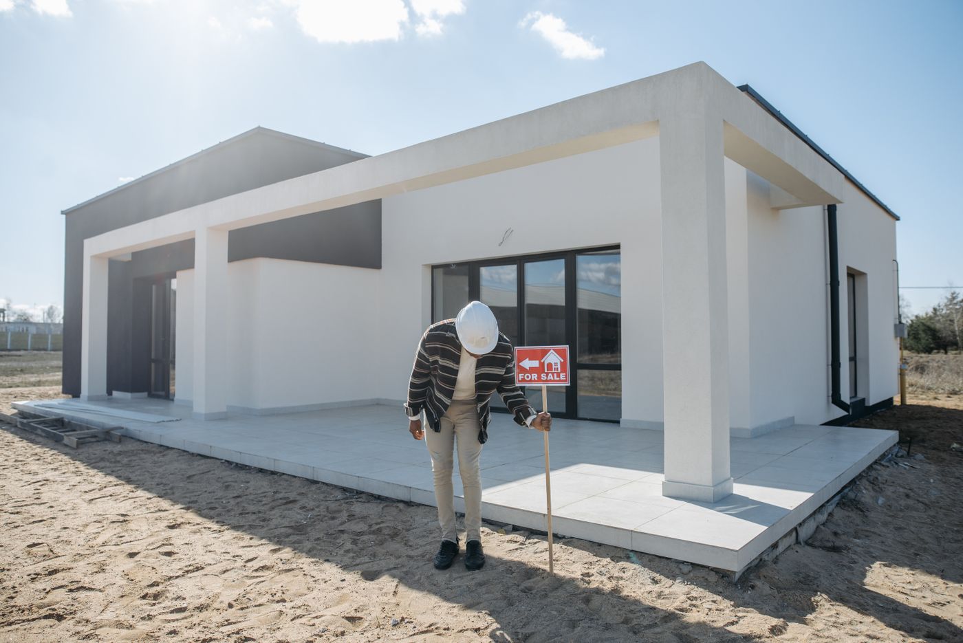 A property buyer on the phone at a house under renovation