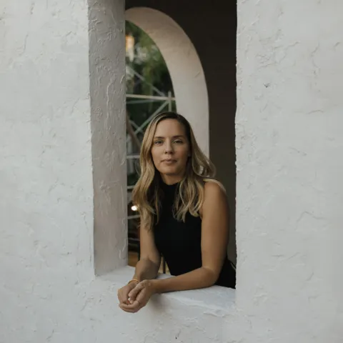 Esther Stewart facing out of a window in Palm Beach