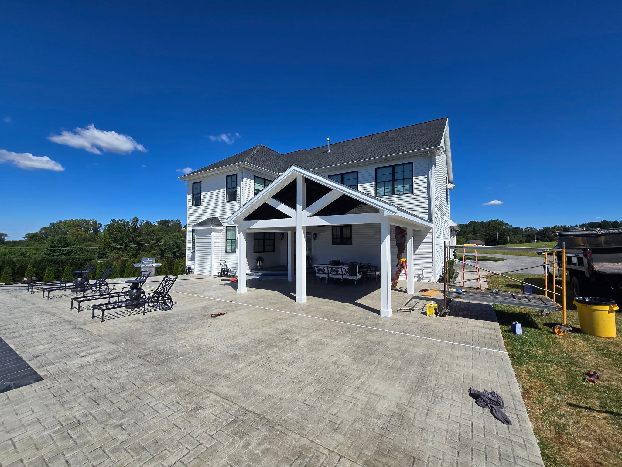 Finished custom home built by Harcon Services with a timber truss entry and wide concrete drive