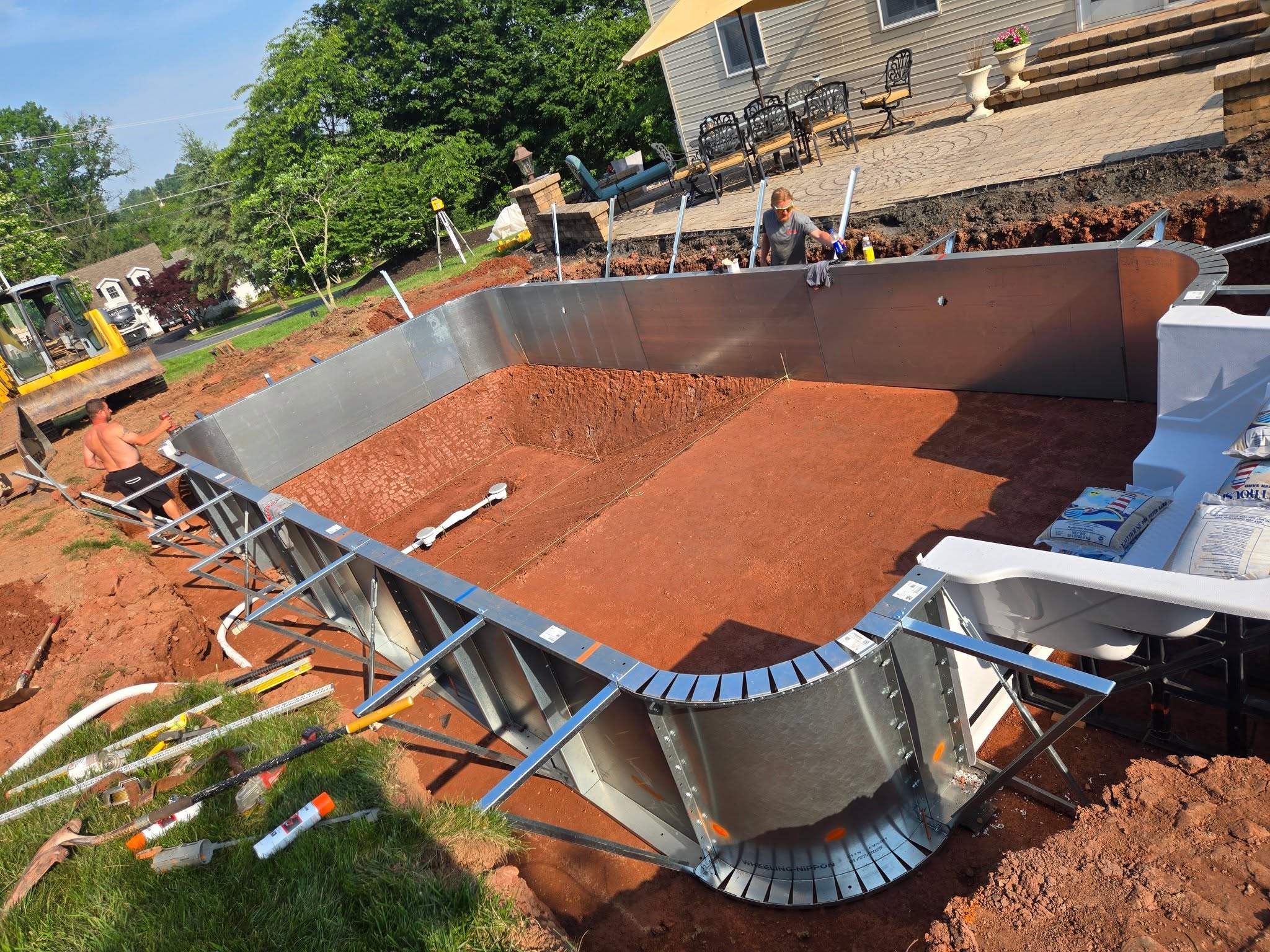 Steel pool wall panels braced in place before concrete is poured