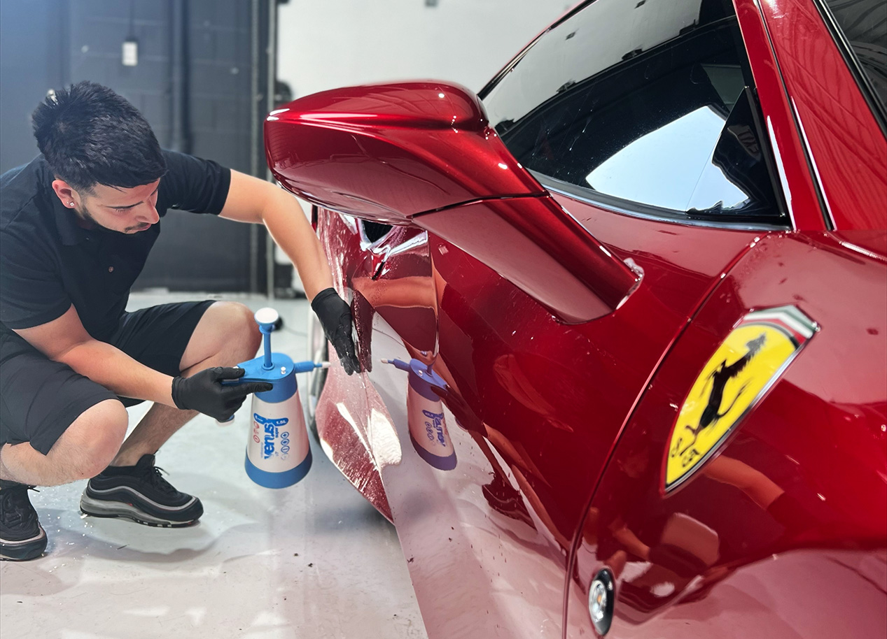 Derek working on Ferrari in automotive customization shop