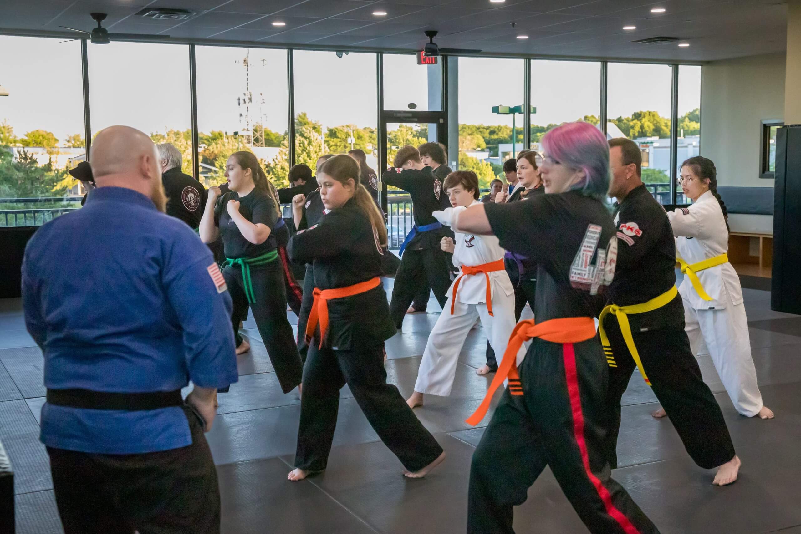 Young children practicing martial arts kicks in the dojo
