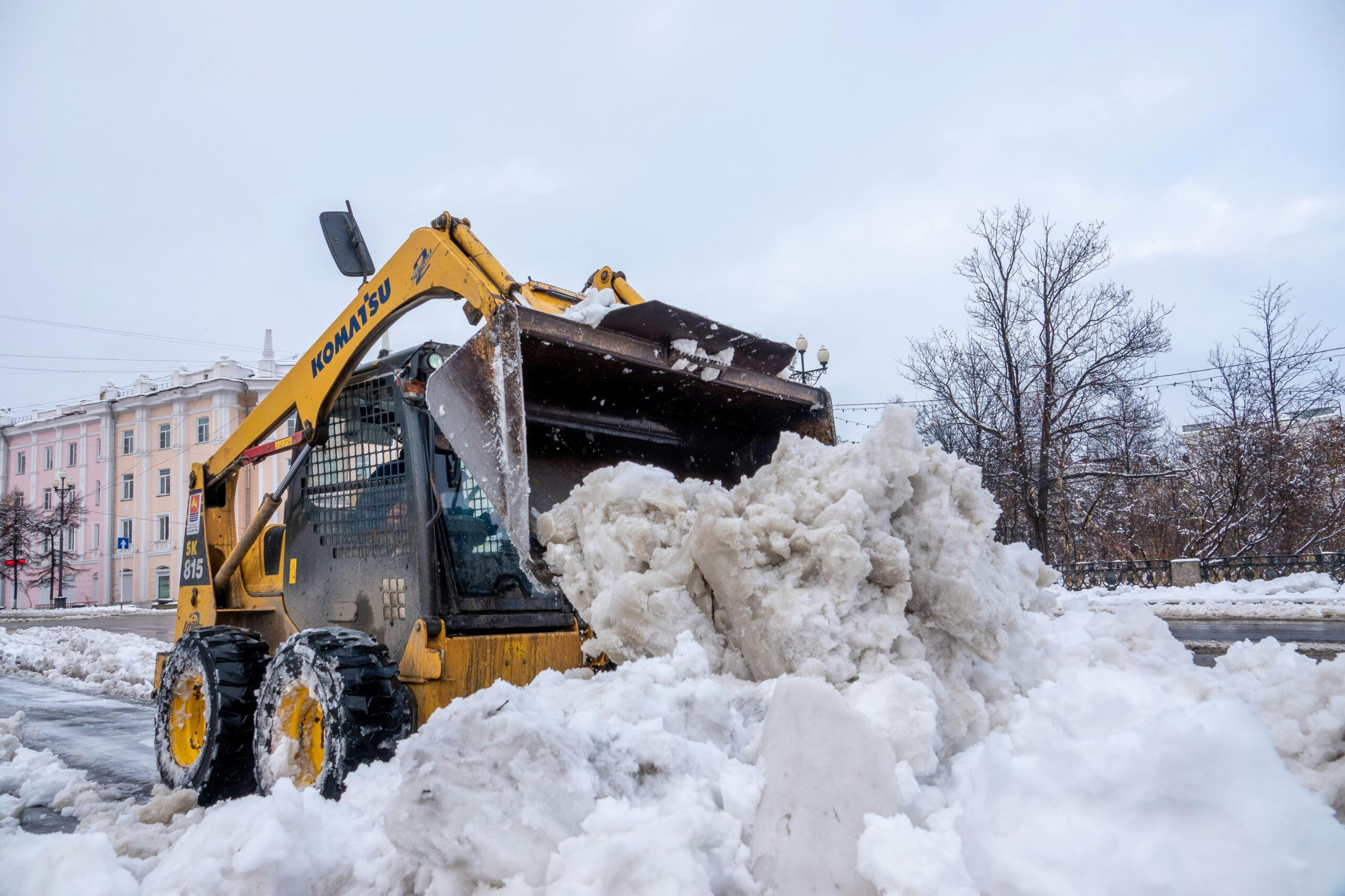 Trailblazers winder crew plowing a parking lot with a bobcat
