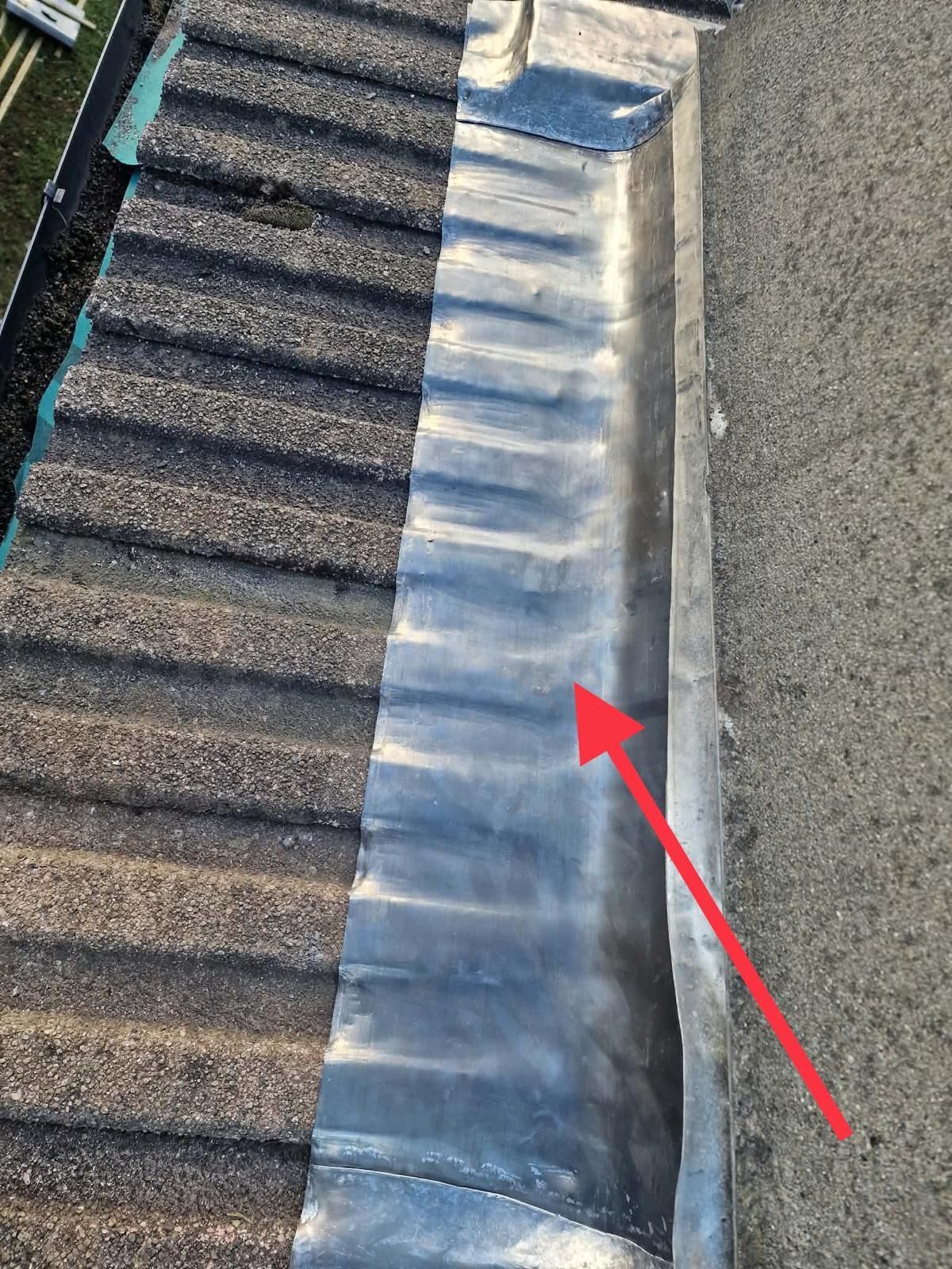 Lead-lined gutter along a rendered chimney with concrete tiles re-laid in Ballsbridge, Dublin 4