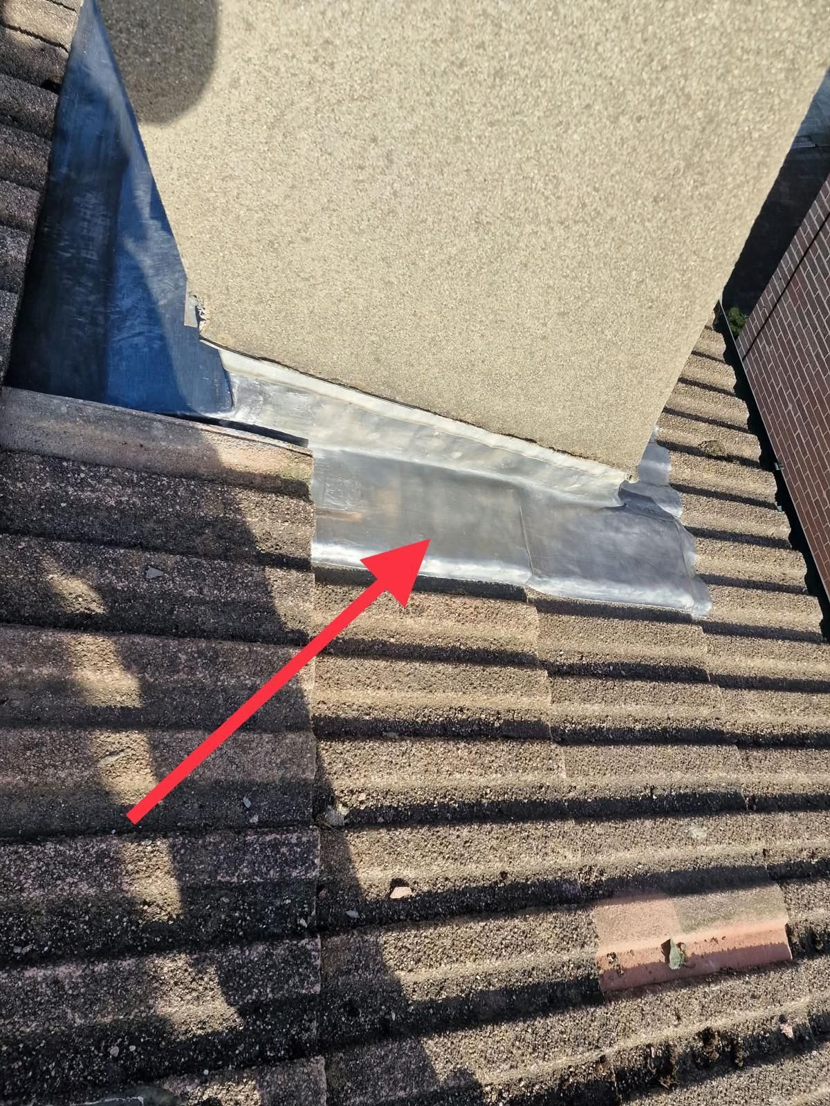 New lead apron at the base of a rendered chimney with concrete roof tiles in Ballsbridge, Dublin 4