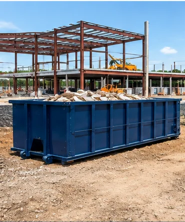 Blue roll-off dumpster loaded with debris at a commercial construction site