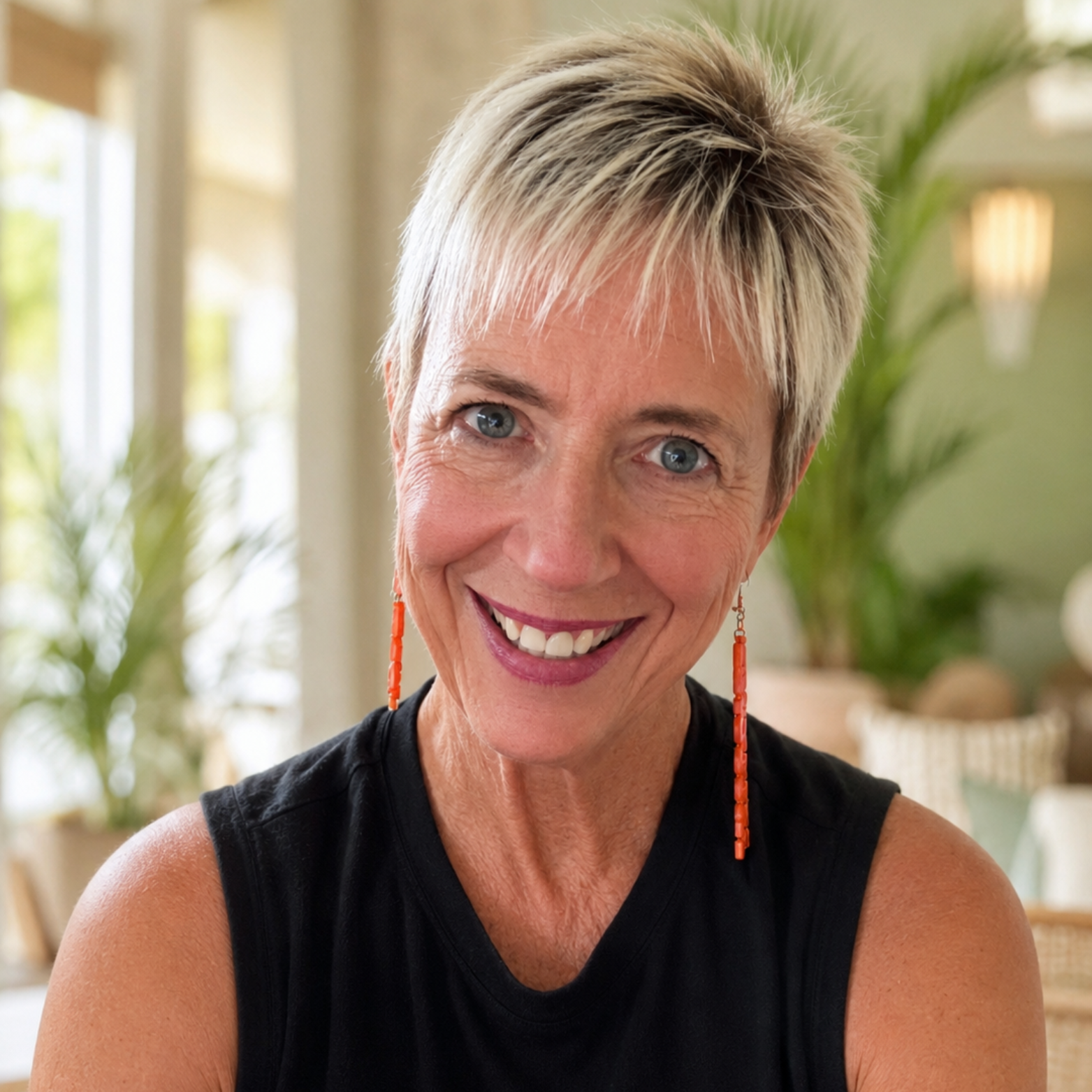 Brenda Kerns, founder of Go Babes Travel, smiling in a welcoming travel-inspired setting