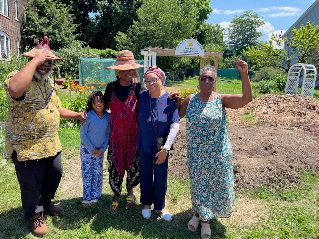 Kariem with friends and family in a community garden