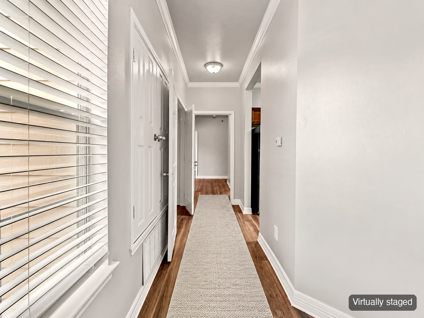 Hallway with runner rug (virtually staged)