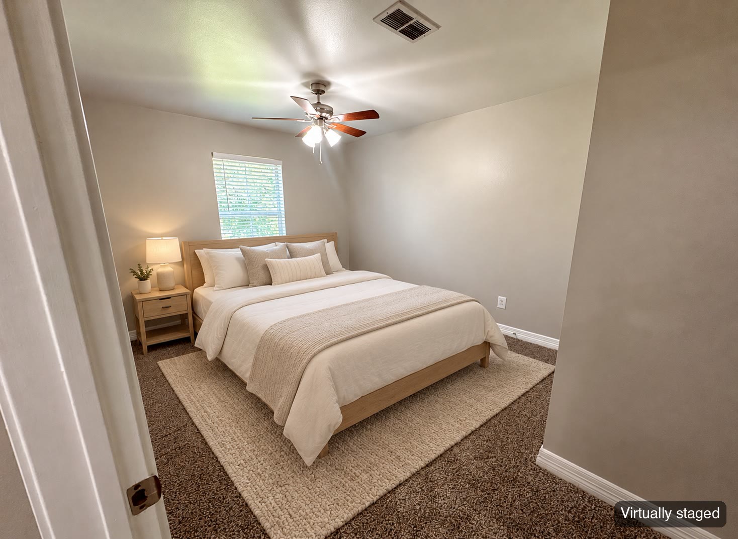 Bedroom with window and ceiling fan (virtually staged)