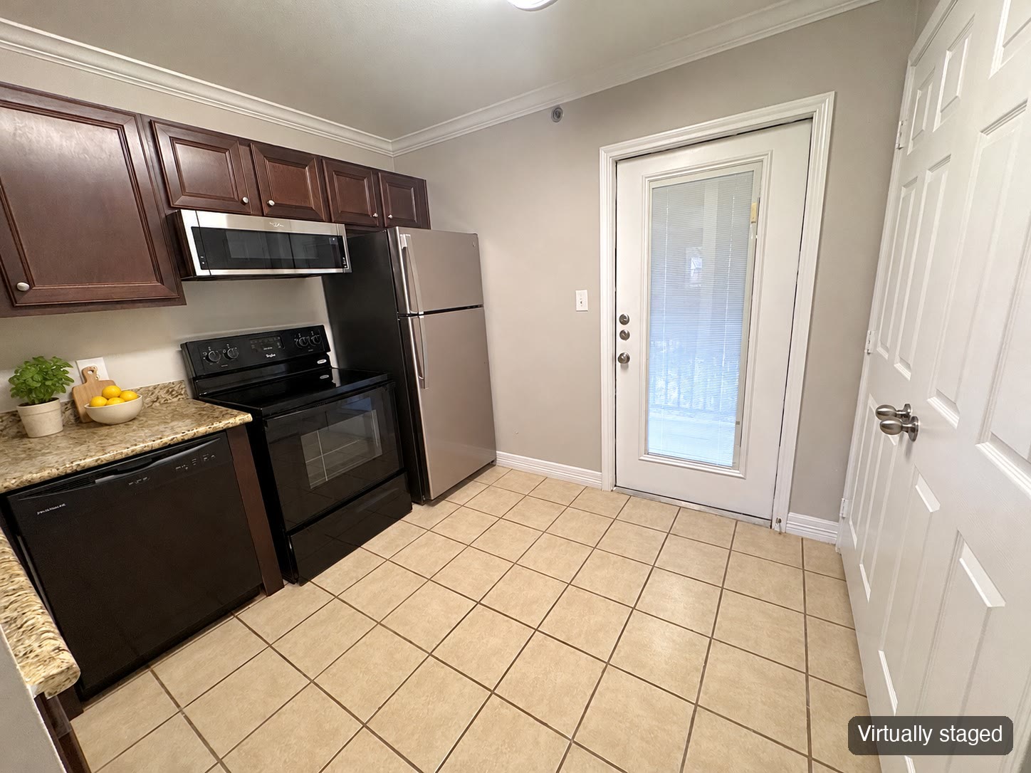 Kitchen with patio door (virtually staged)