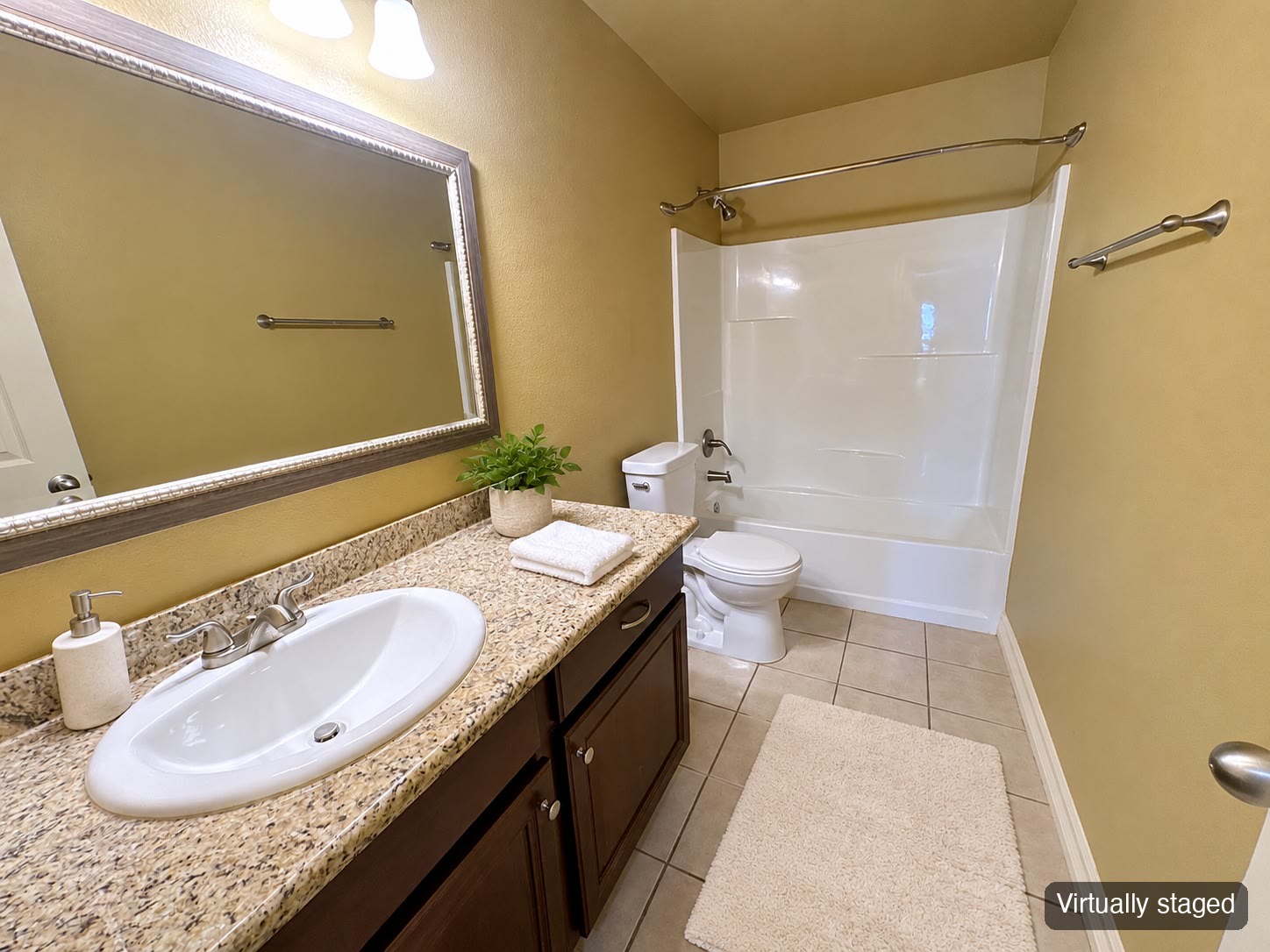 Bathroom with large mirror and tub (virtually staged)