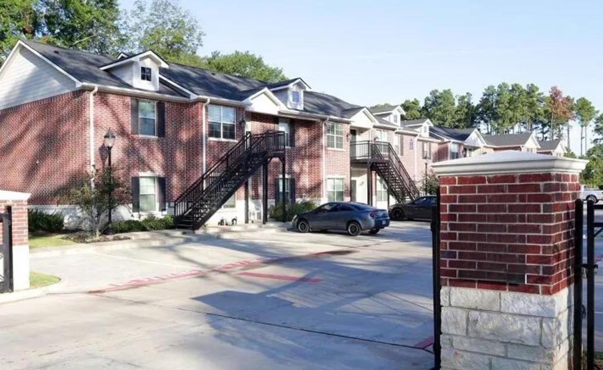 Parking area with brick buildings and exterior stairways