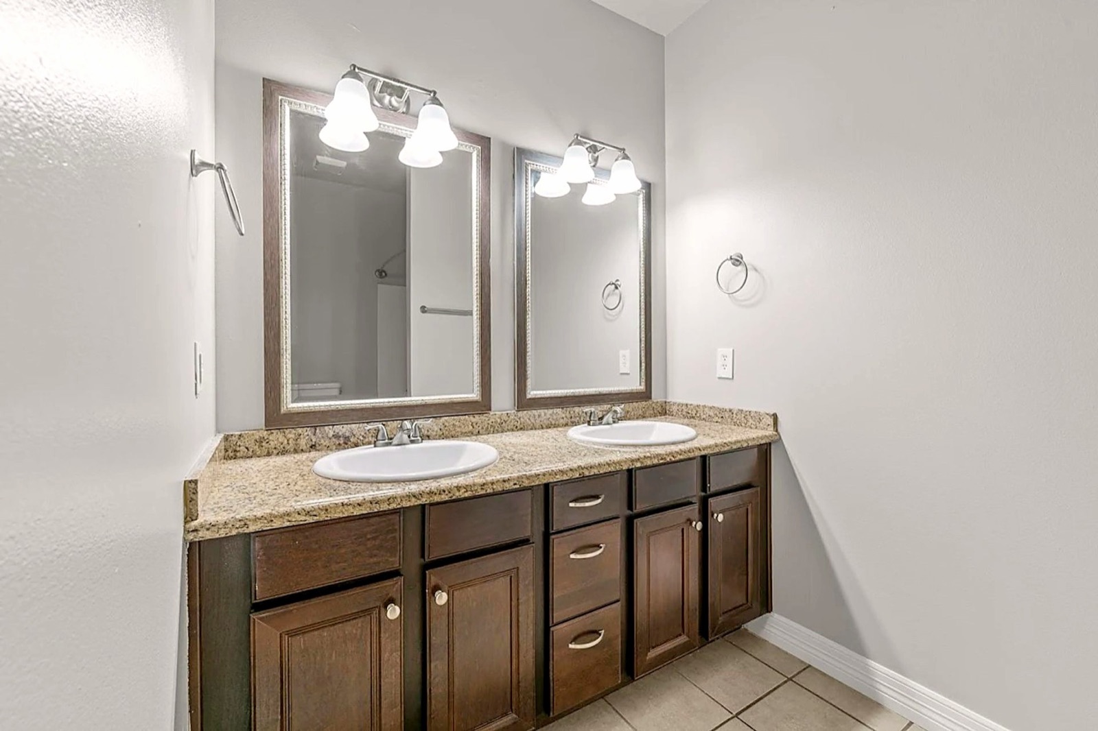 Double-vanity bathroom with granite counters in a 2 bedroom apartment at Grace Pointe, Longview, TX