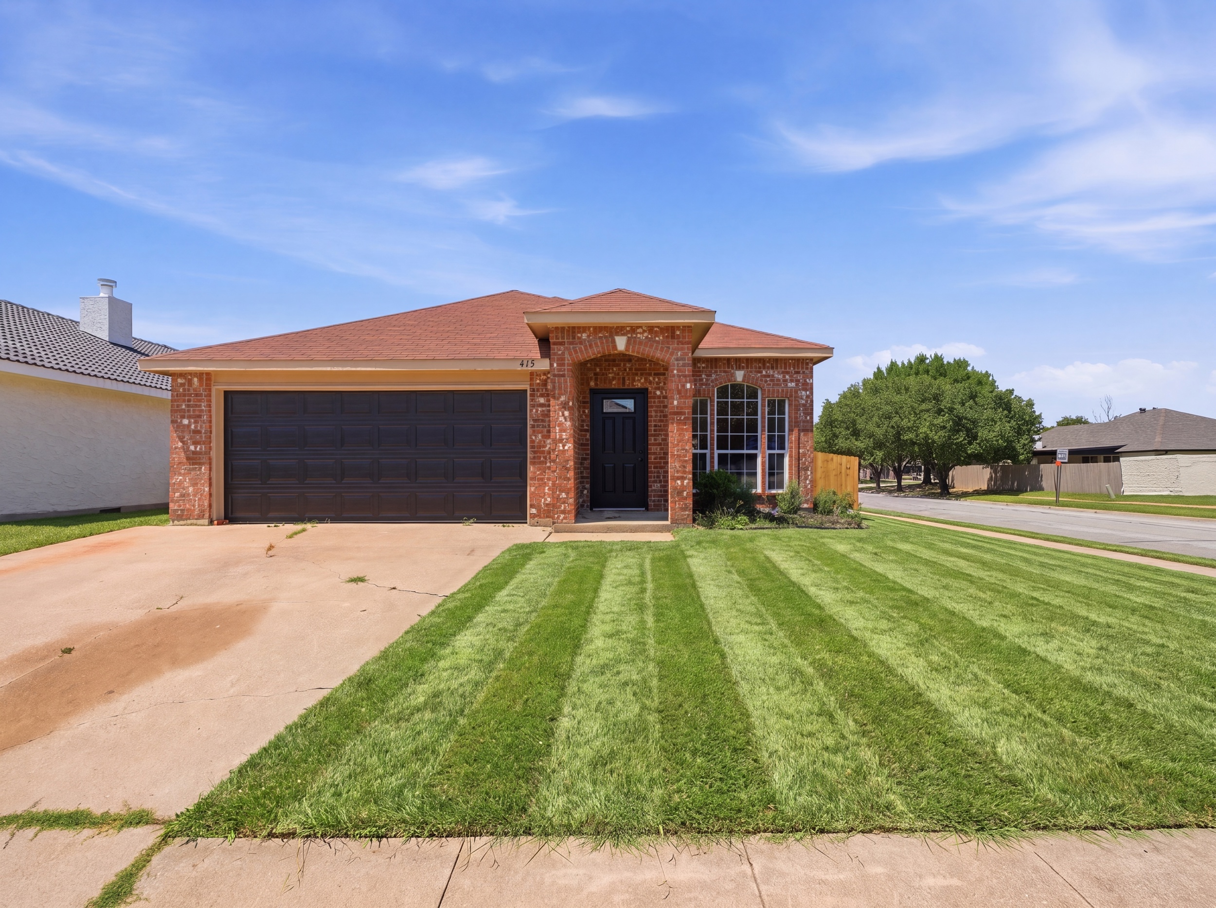 415 Cross Cut Drive front exterior by Kaptiv Media — squared to the house, level, correctly exposed brick and sky