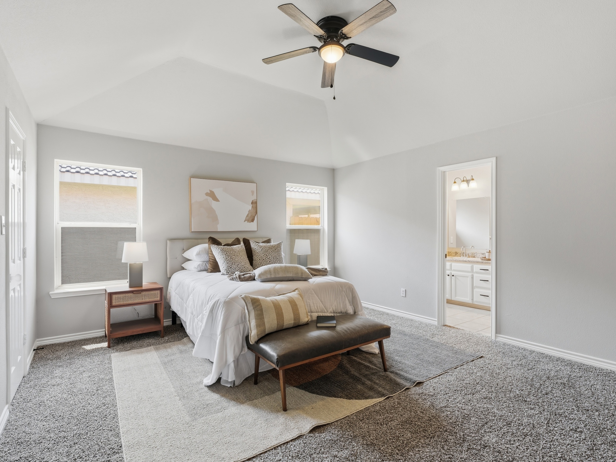 Primary bedroom photographed by Kaptiv Media — level, true colour, ensuite visible through the doorway
