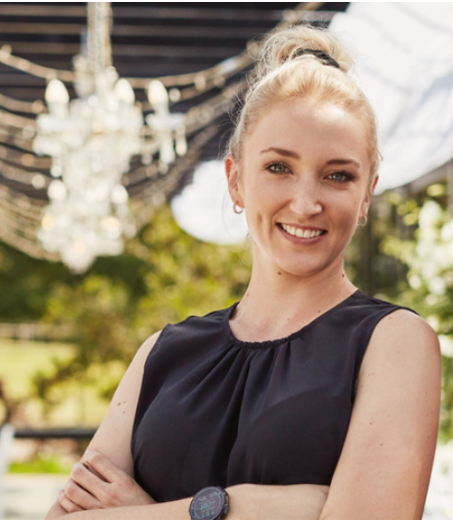 happy white female wedding planner smiling at a wedding