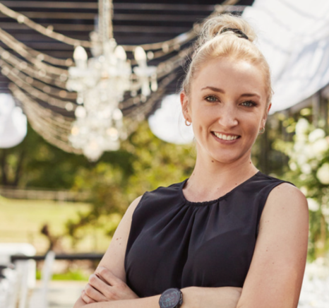 interracial couple kissing at outdoor wedding