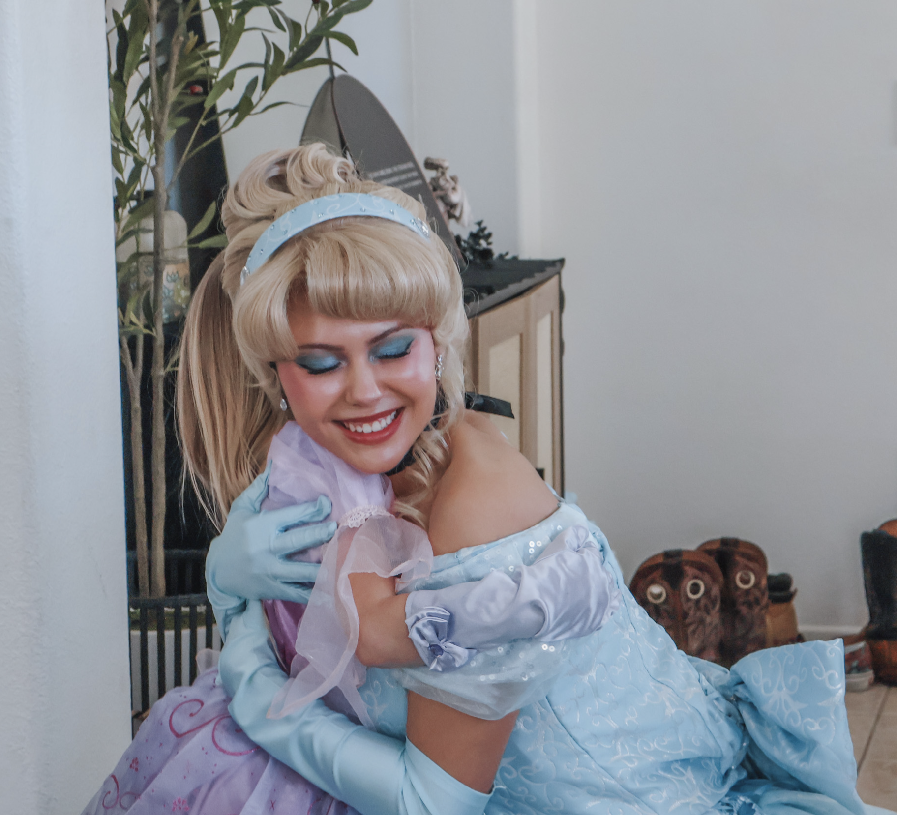 Cinderella sharing a warm hug with a young party guest